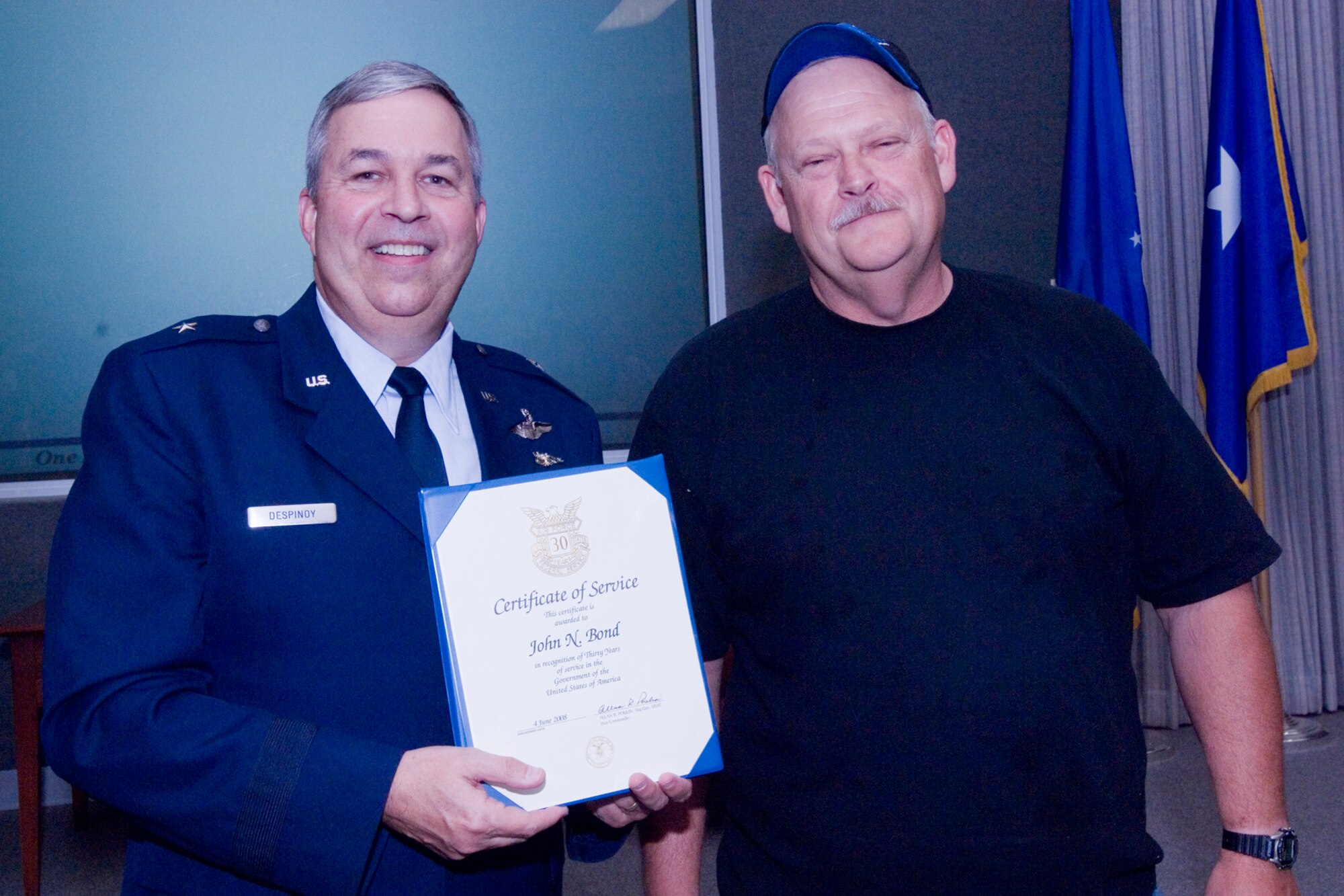 GRISSOM AIR RESERVE BASE, Ind., -- Brig. Gen. Dean Despinoy, 434th Air Refueling Wing commander, left, presents a 30-year certificate and pin to John Bond, a KC-135R mechanic assigned to the 434th Aircraft Maintenance Squadron. The presentation was made as part of a civilian commander's call held recently. (U.S. Air Force photo/Tech. Sgt. Doug Hays)