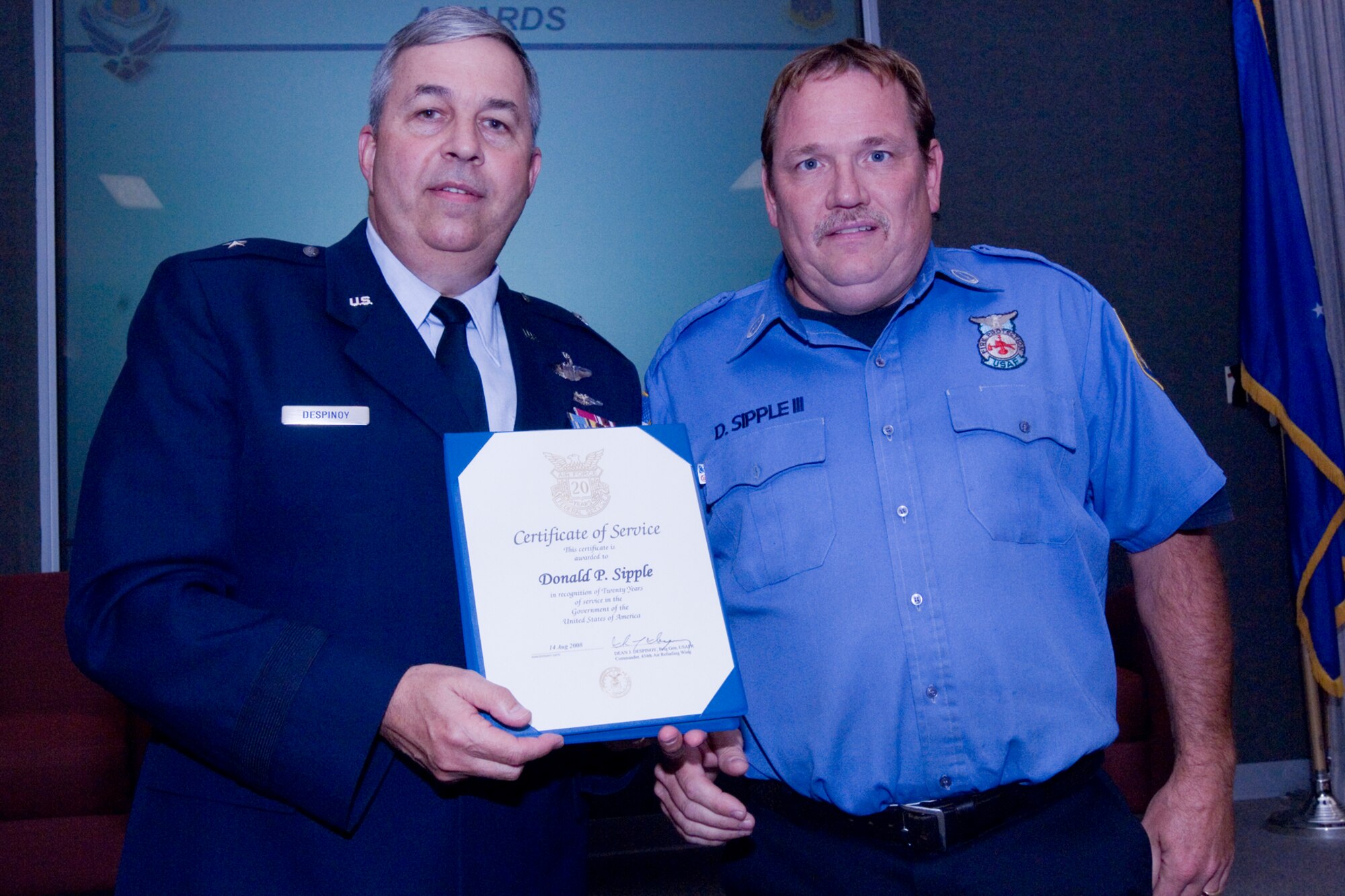 GRISSOM AIR RESERVE BASE, Ind., -- Brig. Gen. Dean Despinoy, 434th Air Refueling Wing commander, presents a 20-year pin and certificate to Donald Sipple III, Grissom fire fighter. The presentation was made as part of a civilian commander's call held recently. (U.S. Air Force photo/Tech. Sgt. Doug Hays)