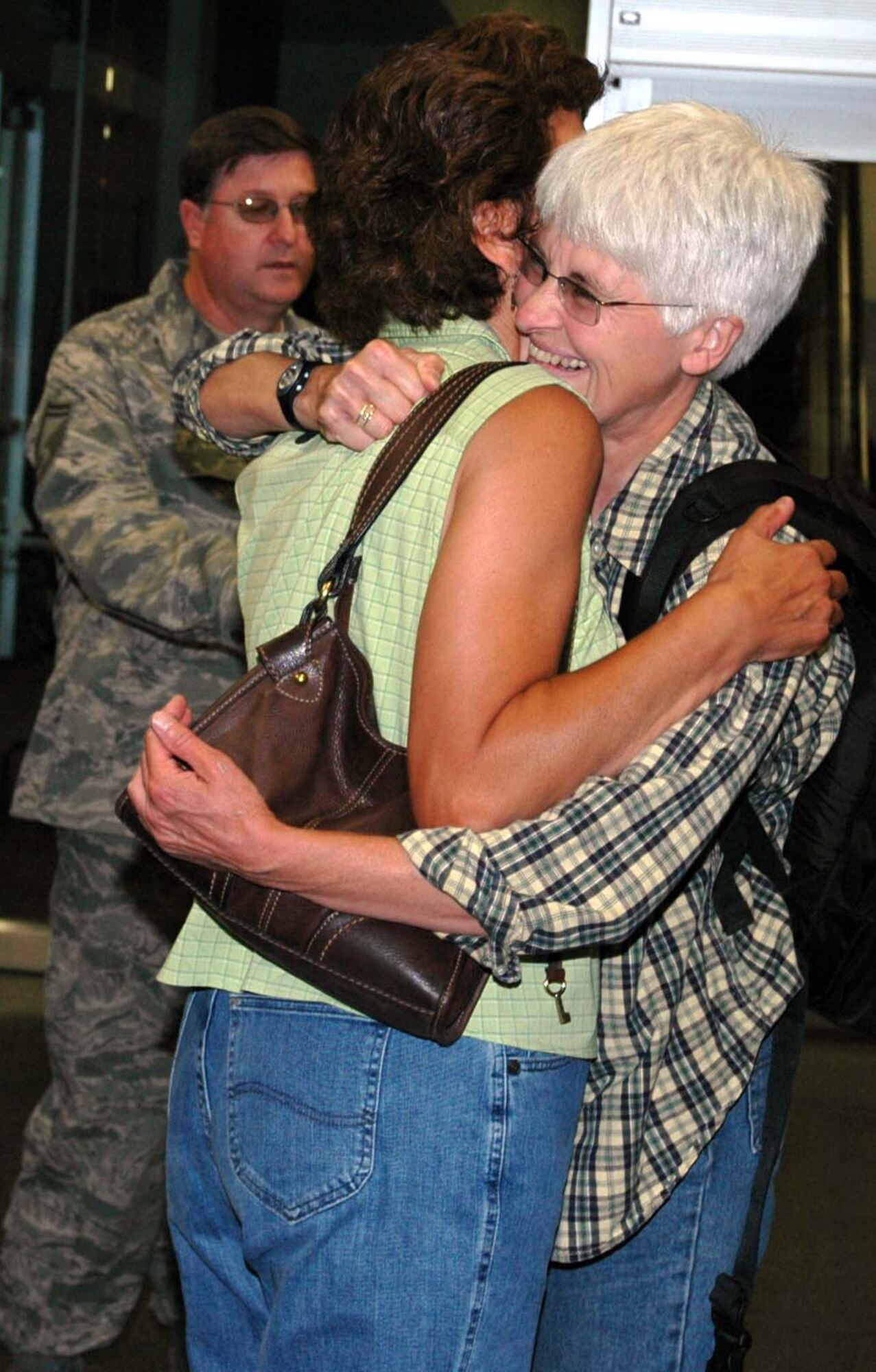 Col. Nina Gilberg (right), 934th Aeromedical Staging Squadron, is welcomed home by Lt Col. Phyllis Lawver, 934 ASTS, after her humanitarian deployment to Suriname South America as Senior Master Sgt. Tim Atchley, 934 ASTS, looks on. The role of the 934th ASTS members was to work alongside with the Surinamese military to provide dental, eye, veterinarian, pharmaceutical, and general health care to the people and animals of Suriname.