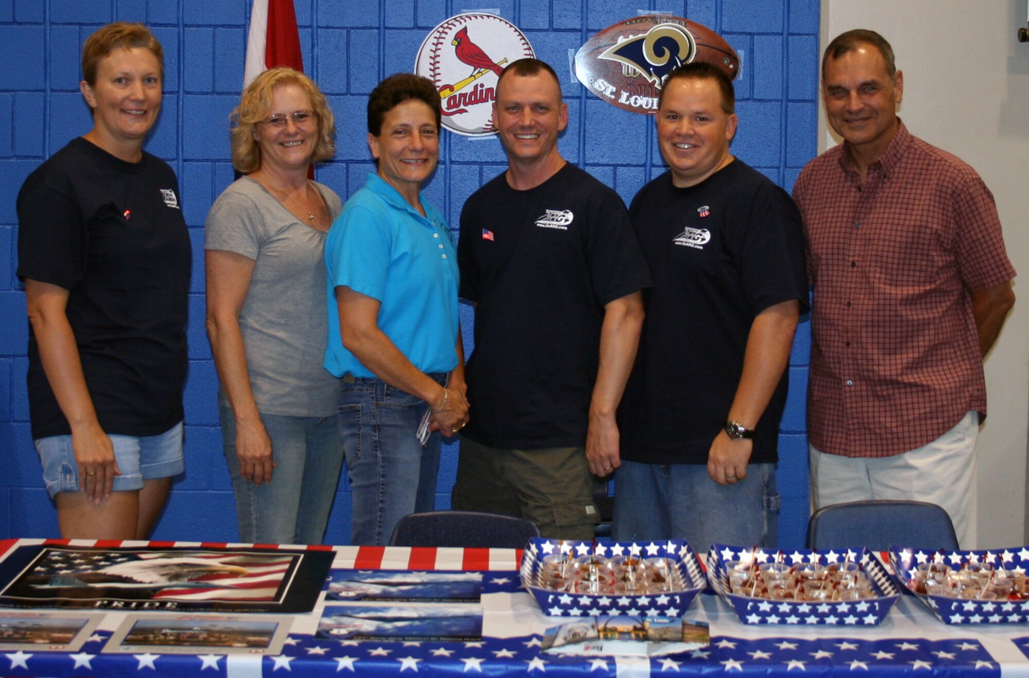 Senior Master Sgt. Angela Varvel, Senior Master Sgt. Chris Akers, Command Chief Master Sgt. Lisa Kessinger, Senior Master Sgt. Robert Wilson, Master Sgt. Richard Champ, and Col. Robert Leeker work the St. Louis stand during the states night at the NCOAGA 40th anniversary conference.