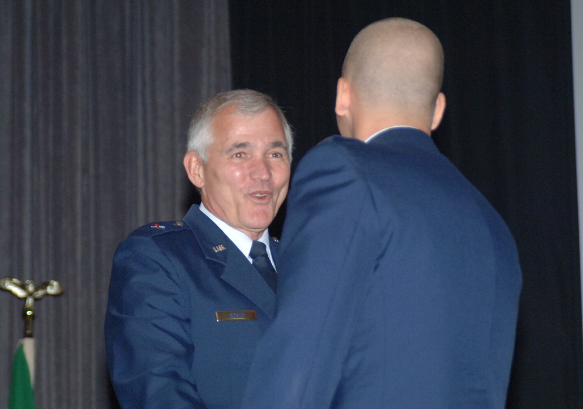 Retired Brig. Gen. Steven Roser congratulates 2nd Lt. Shawn Joaquin, a recent graduate, after receiving his wings Friday. General Roser was the keynote speaker for Specialized Undergraduate Pilot Training class 08-13 graduation. (U.S. Air Force photo by 2nd Lt. George Fowler)
