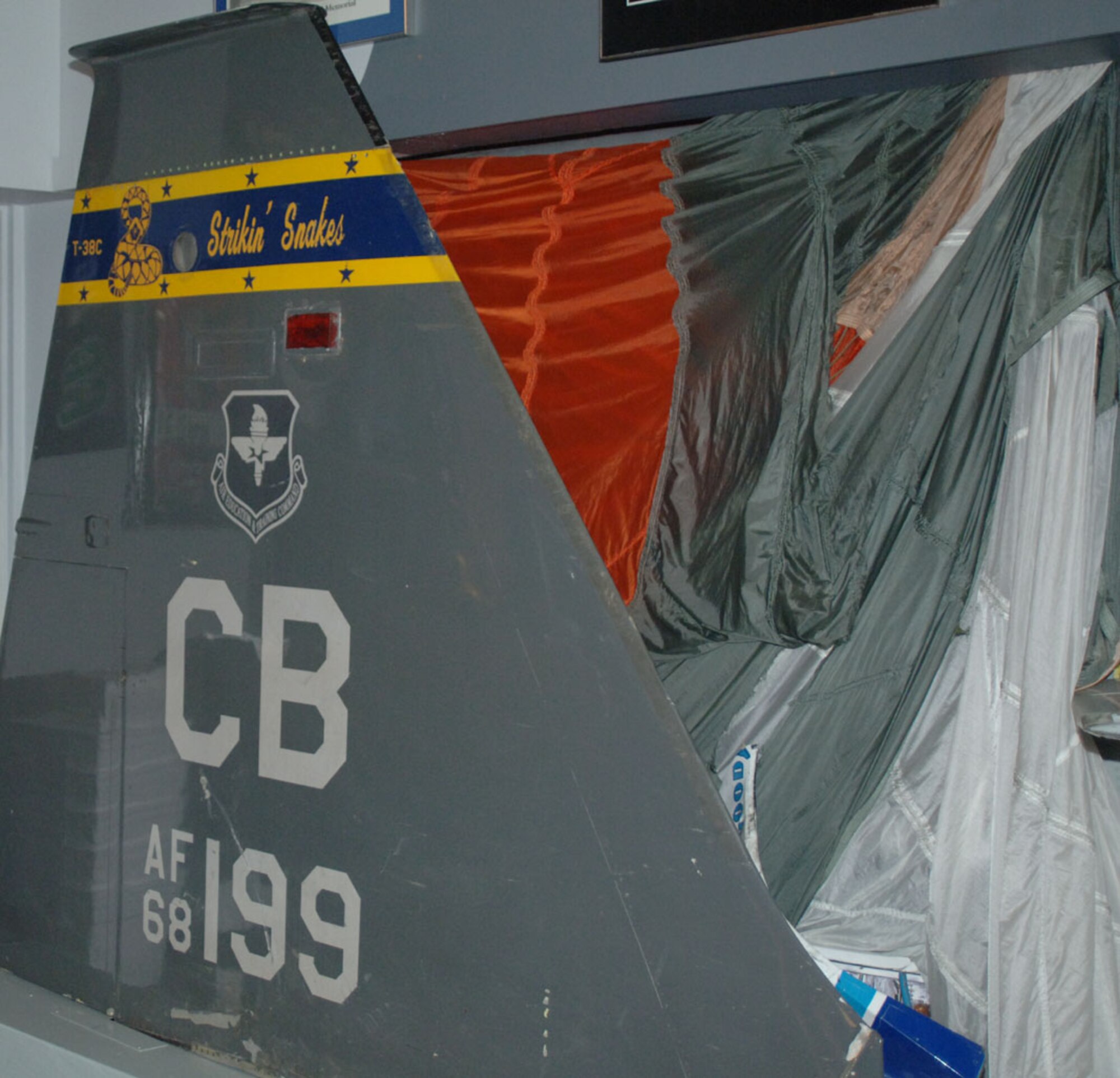 After ejecting safely from a low-level incident last year, the tailfin of the aircraft that Maj. Bill Lester was flying is on display in the 50th FTS heritage room. (U.S. Air Force photo by Senior Airman Danielle Hill)

