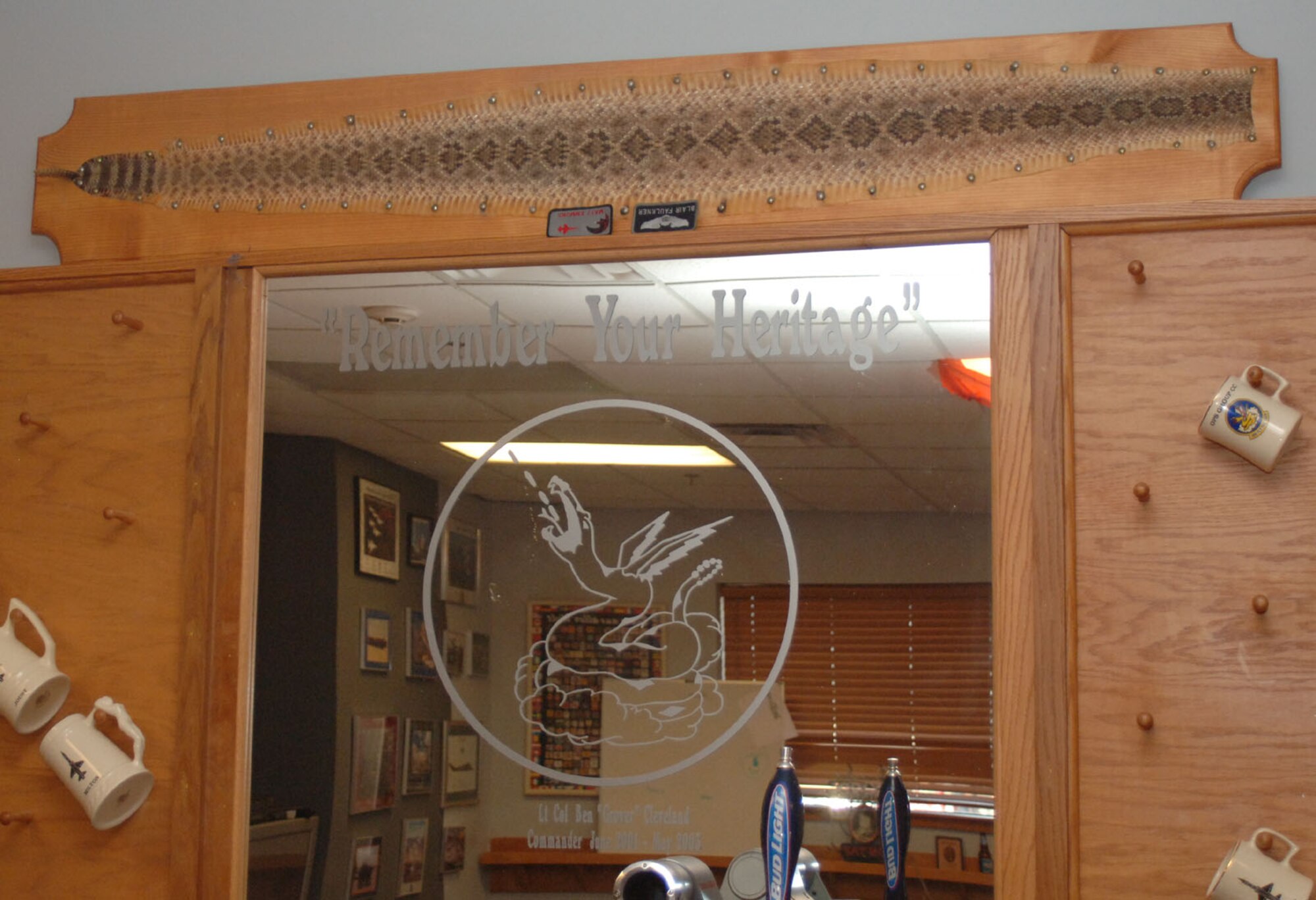 A snake skin is presented over the bar in the 50th Flying Training Squadron’s heritage room. Etched in the glass is the squadron patch and the slogan “Remember your heritage.” (U.S. Air Force photo by Senior Airman Danielle Hill)

