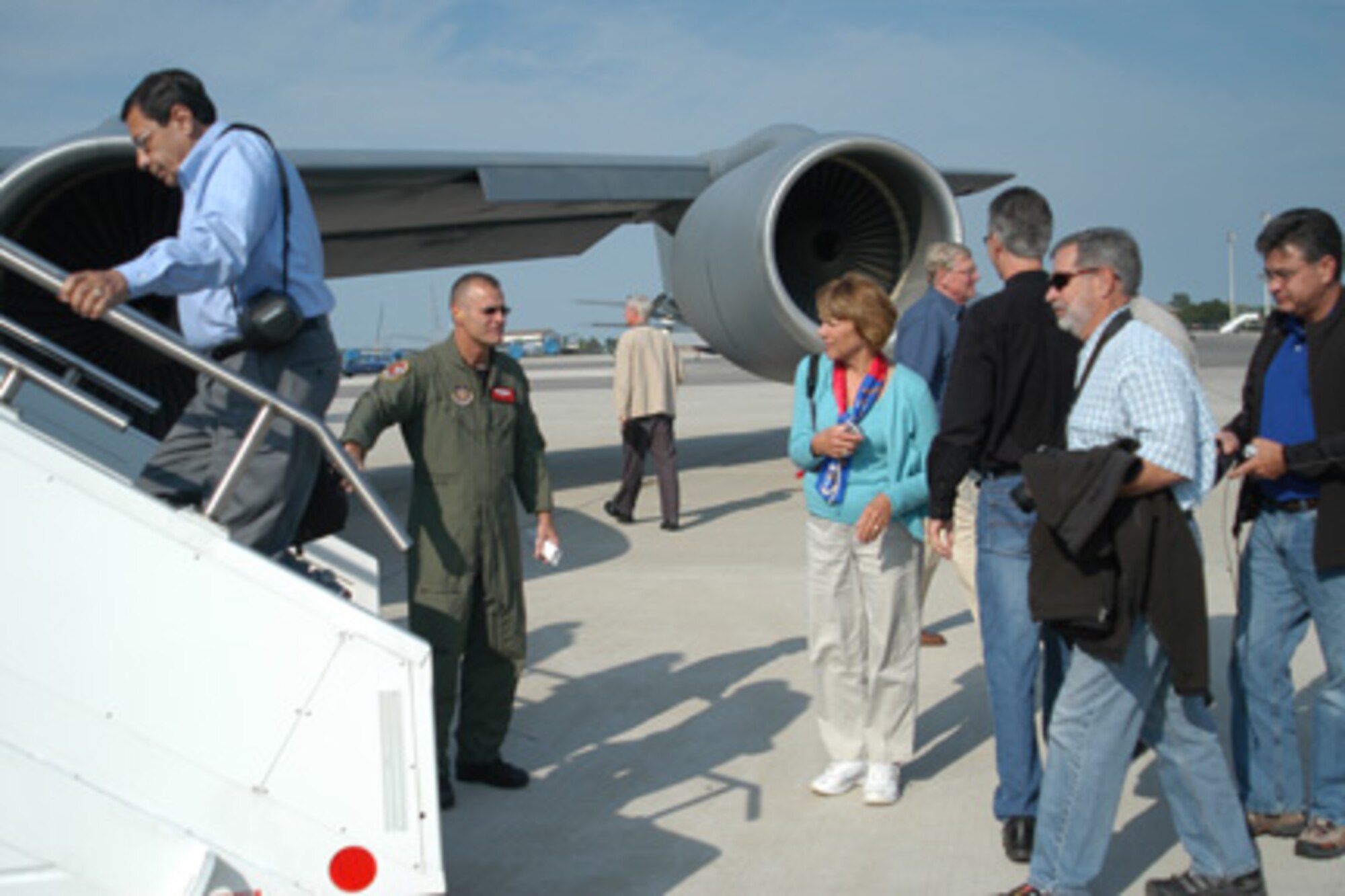 GRISSOM AIR RESERVE BASE, Ind. -- Master Sgt. Bryan Hettinghouse, 74th Aerial Refueling Squadron boom operator, greets Indianapolis-area civic leaders here Aug. 20 as they board a KC-135 for an aerial refueling mission.  During the mission, the civic leaders witnessed aerial refueling operations between the KC-135 Stratotanker and A-10 Thunderbolt II fighter aircraft.  The flight was part of Grissom's on-going civic leader flight program.  (U.S. Air Force photo/Capt. Kelly Howard)