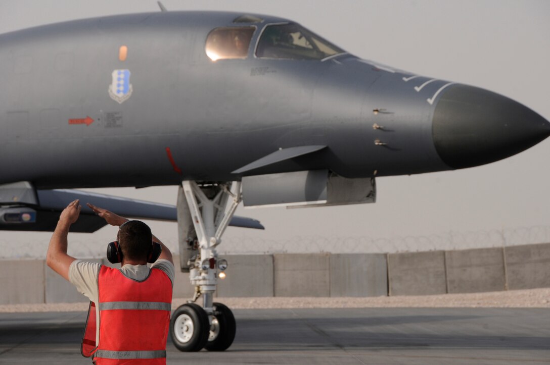 Senior Airman Reilly White, a crew chief assigned to the 379th Expeditionary Aircraft Maintenance Squadron, 34th Aircraft Maintenance Unit, marshals a B-1 Lancer from its parking spot Aug. 21, 2008, at an undisclosed air base in Southwest Asia.  Prior to flight, crew chiefs inspect and perform various functional checks of the aircraft as well as ensure that the aircraft has been properly serviced with fuel, hydraulic fluid and liquid oxygen.  B-1s assigned to the 379th are regularly called upon for precision air strikes in support of Operations Iraqi Freedom and Enduring Freedom.  Airman White, a native of Williamsport, Pa., is deployed from Ellsworth Air Force Base, S.D. (U.S. Air Force photo by Tech. Sgt. Michael Boquette/Released)