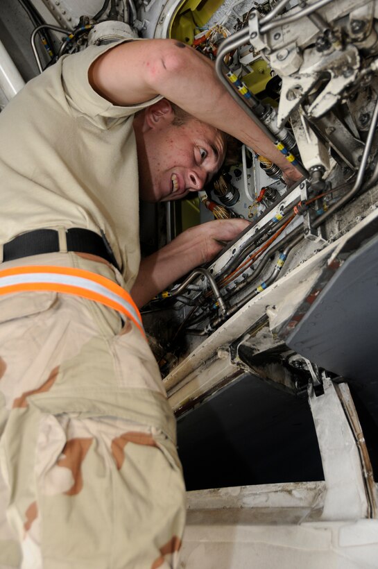 Airman 1st Class Kyle Stinger, 379th Expeditionary Aircraft Maintenance Squadron, 34th Aircraft Maintenance Unit, puts everything back together again after replacing a fire detector control unit on a B-1 Lancer Aug. 21, 2008, at an undisclosed air base in Southwest Asia.  Airman Stinger is an electrical and environmental systems specialist who was called in to quick turn and fix an aircraft that was due to fly.  B-1s assigned to the 379th are regularly called upon for precision air strikes in support of Operations Iraqi Freedom and Enduring Freedom.  Airman Stinger, a native of Saint Louis, Mo., is deployed from Ellsworth Air Force Base, S.D. (U.S. Air Force photo by Tech. Sgt. Michael Boquette/Released)