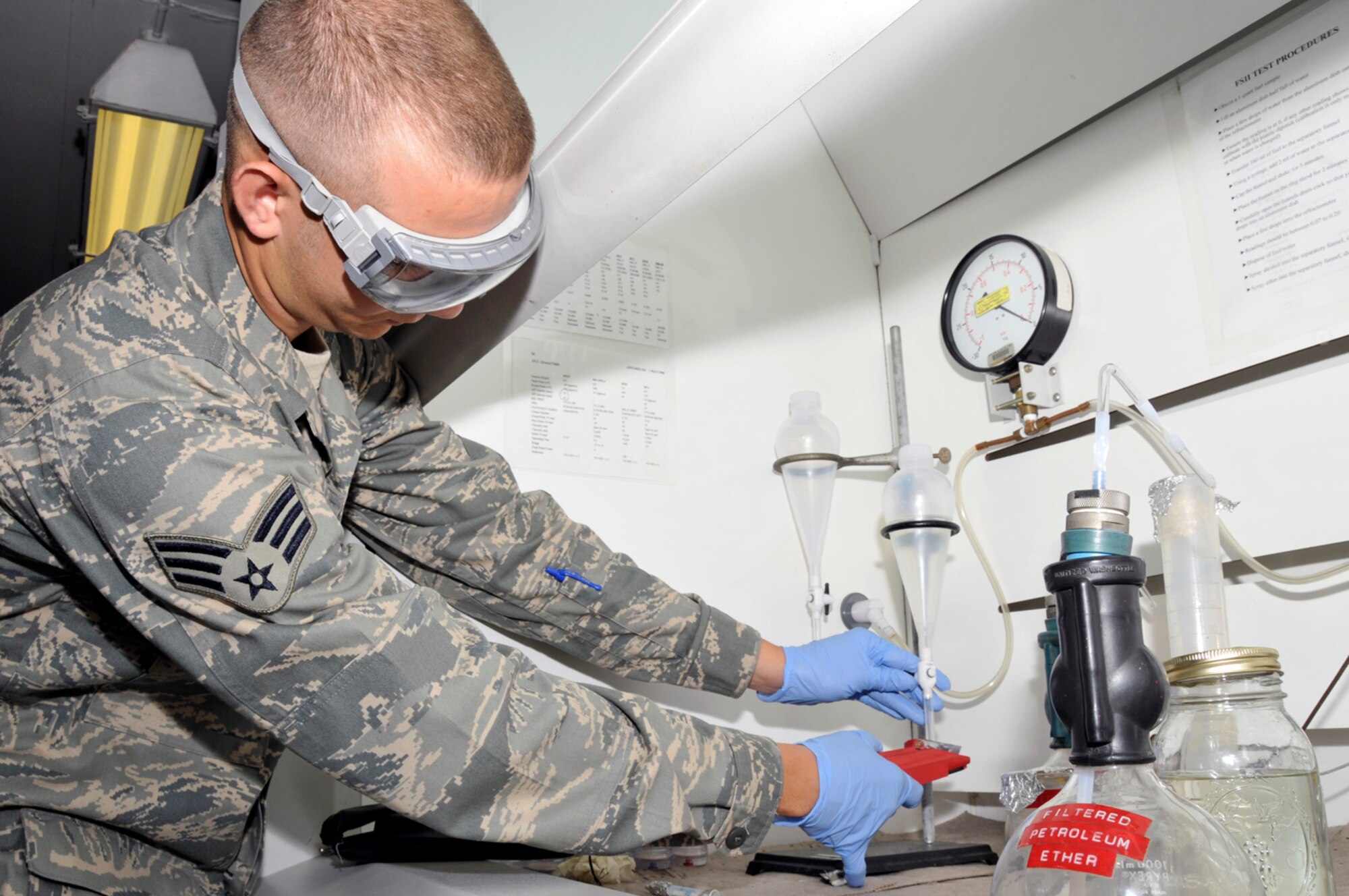 Senior Airman Matthew Young, 48th Logistics Readiness Squadron, fuel lab technician puts a sample of fuel onto a refractor Aug. 12 at RAF Lakenheath, England. The refractor is used to test how much water is present in the fuel. (U.S. Air Force photo by Airman Perry Aston) 