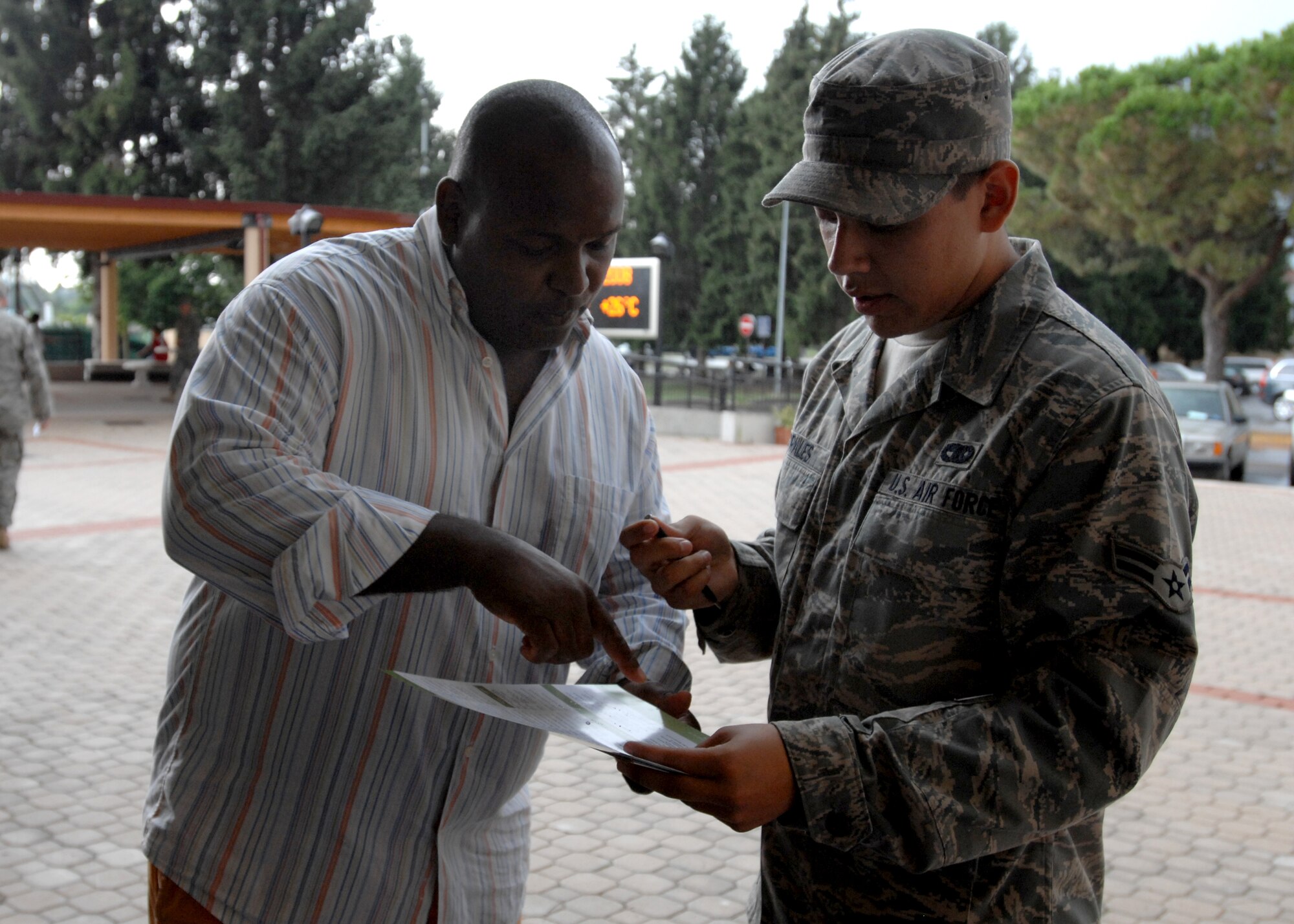 AVIANO AIR BASE, Italy --  Ricky Lucas helps Airman 1st Class Guadalupe Morales learn more about the University of Maryland University College, Aug. 8 at the Aviano Education Center.  UMUC offers many classes on site and though correspondence to help Airman achieve their Community College of the Air Force Degree (CCAF) and civilian degrees.  (U.S. Air Force photo/Airman 1st Class Tabitha M. Mans)