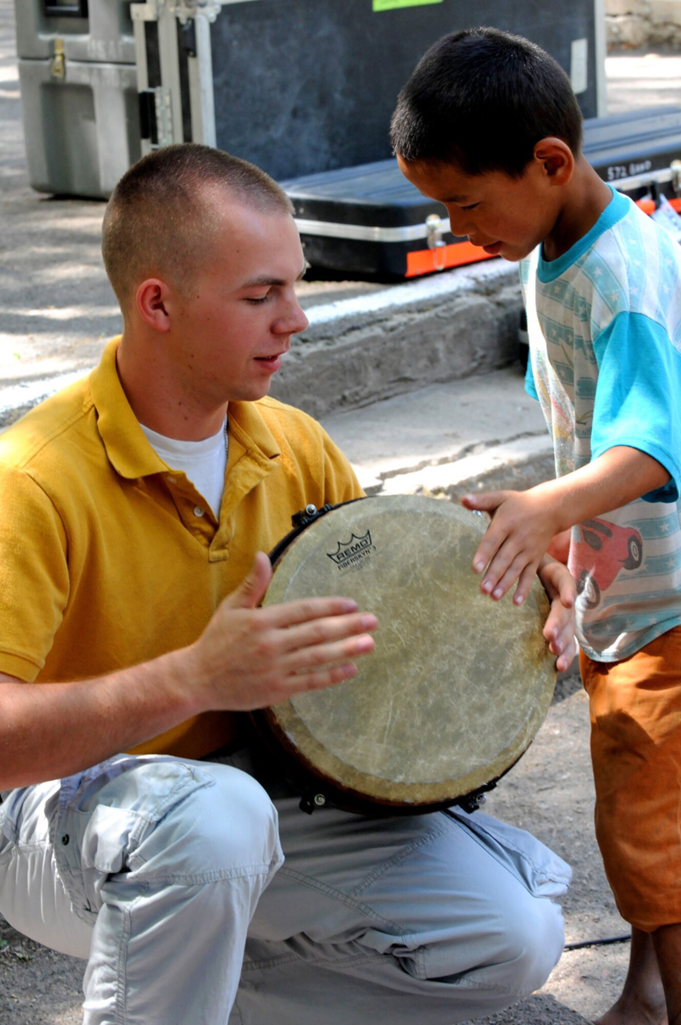 08/12/2008 - MANAS AIR BASE, KYRGYZ REPUBLIC -- Airman 1st Class Matthew Adams, 572nd Air Force Band guitarist, shares the joys of music during a concert at Tok Mok II, a local Kyrgyz orphanage, Aug. 14. During their ten day tour, the Sirocco band performed 15 concerts; six for Air Force personnel and seven in the surrounding communities. (Air Force photo / Airman 1st Class Ruth Holcomb)