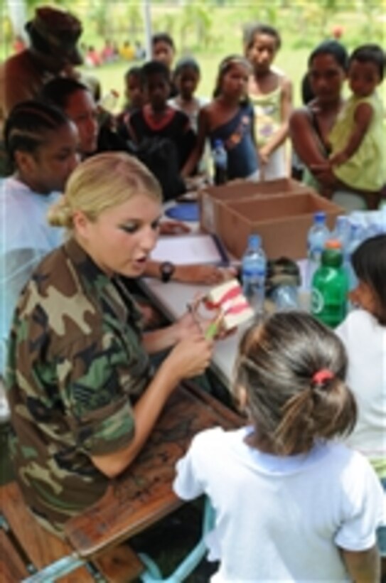 U.S. Air Force Senior Airmen Alexandra Olson, embarked aboard the USS Kearsarge (LHD 3), teaches children dental hygiene during a humanitarian mission in Betania, Nicaragua, on Aug. 17, 2008.  The Kearsarge, which is deployed with various embarked units and nongovernmental organizations, is supporting the Caribbean phase of Continuing Promise 2008, an equal partnership mission between the United States, Canada, the Netherlands, Brazil, Nicaragua, Panama, Columbia, Dominican Republic, Trinidad and Tobago and Guyana.  