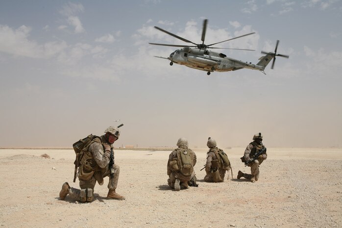 Members of 1st Platoon, Company A, 4th Assault Amphibious Battalion, Multi-National Force - West, await air transport aboard a CH-53E helicopter Aug. 22 at Al Asad Air Base, Iraq.  The battalion, now tasked as the quick-reaction force for MNF-W after four months of serving as a provincial rifle team, is learning their new responsibilities as the QRF.  The Marines constantly hone their abilities and teamwork.