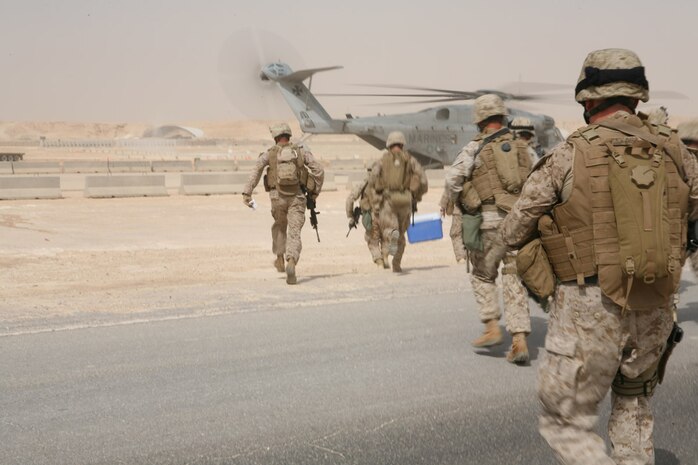 Sgt. Henry L. Butts, a team leader with 1st Platoon, Company A, 4th Assault Amphibian Battalion, Multi-National Force - West, watches as the CH-53E helicopter he’s riding in prepares for landing Aug. 22 at Al Asad Air Base, Iraq.  Once the ramp was lowered, Butts and the other Marines in his stick sprinted to their positions to provide support for the assault stick of 1st Plt. The platoon was learning quick reaction force maneuvers.  The battalion, now tasked as the QRF for MNF-W after four months of serving as a provincial rifle team, is learning their new responsibilities make western Iraq safer.