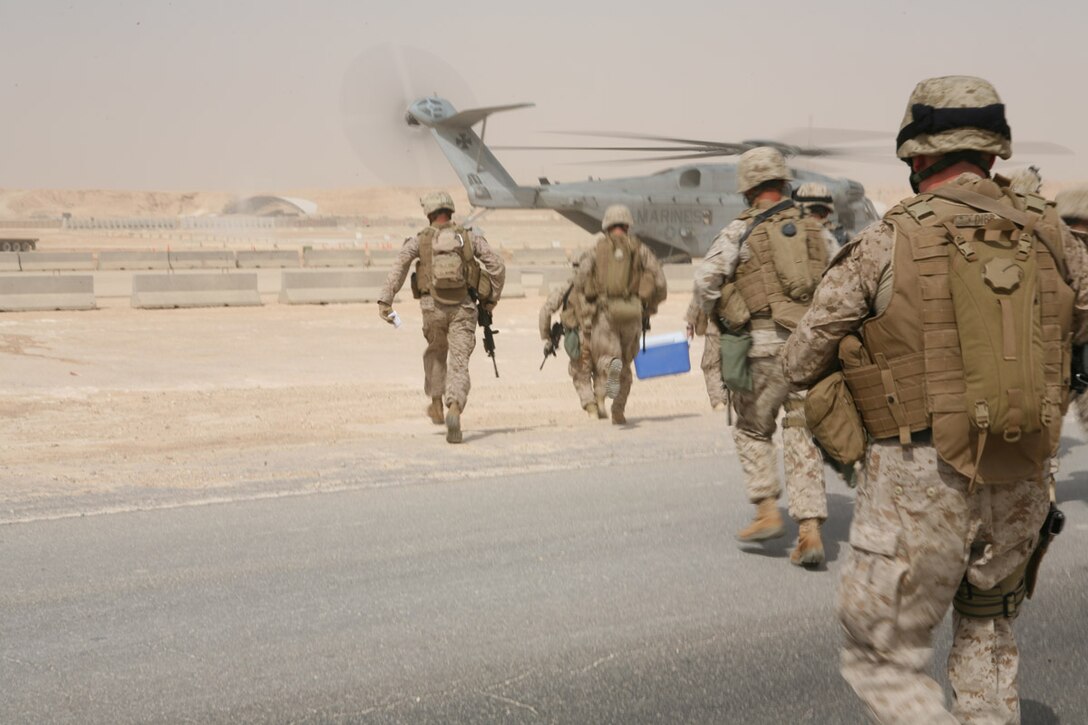 Marines from 1st Platoon, Company A, 4th Assault Amphibian Battalion, Multi-National Force - West, hustle to the ramp of an awaiting CH-53E helicopter Aug. 22 at Al Asad Air Base, Iraq.  The platoon is learning quick reaction force tactics in order to be proficient for the battalion’s newest mission as the QRF for MNF-W.