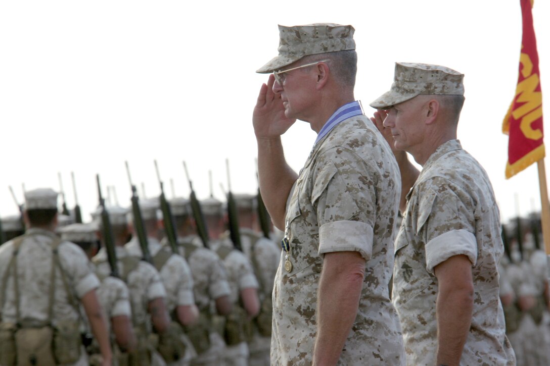 Lt. Gen. John F. Goodman, (left ) outgoing commander, U.S. Marine Corps Forces, Pacific, and Brig. Gen. Rex C. McMillian, (right) deputy commanding general, MarForPac, salute units as they pass during Goodman?s change of command and retirement ceremony at the flightline here Aug. 22.