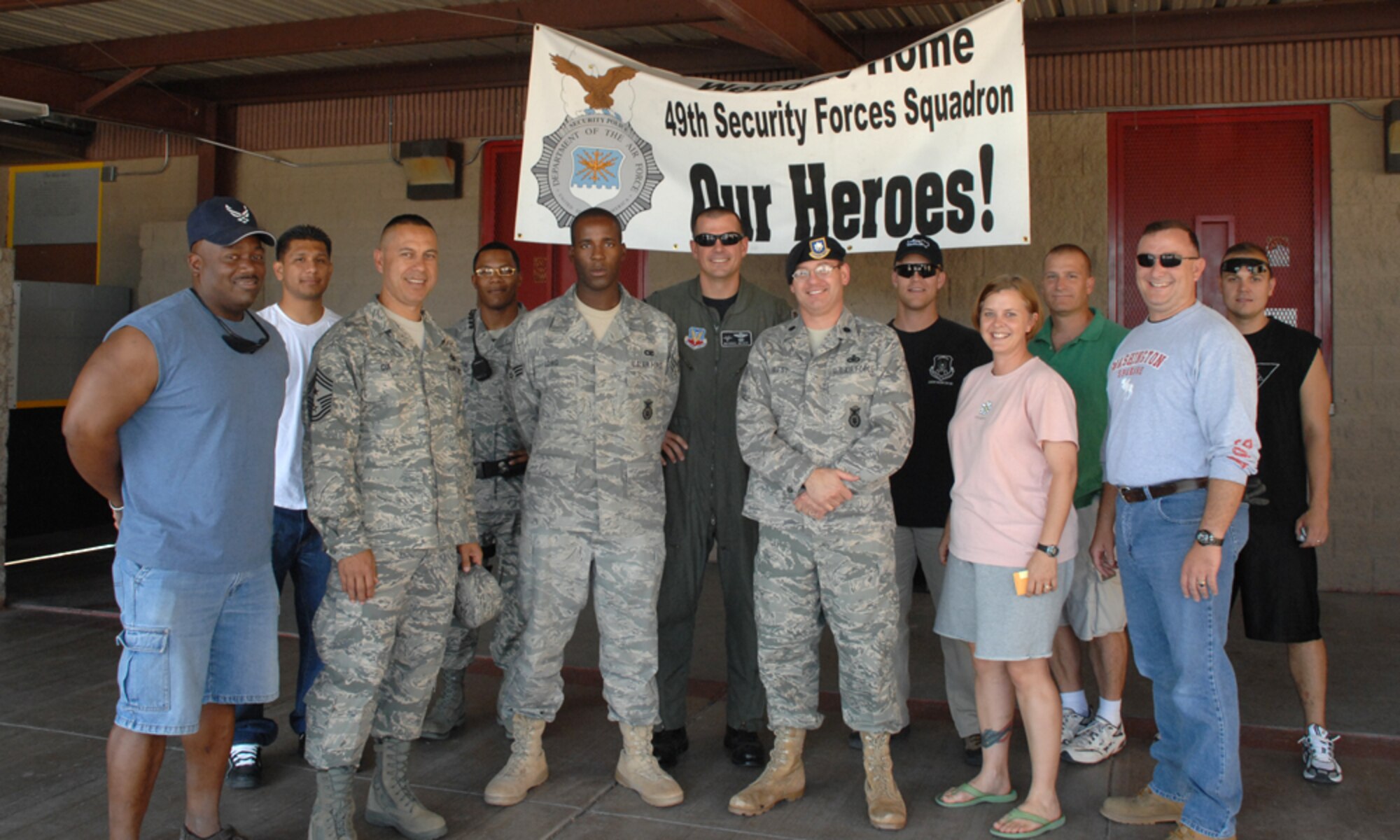 Members of Team Holloman pose for a photo at Holloman Air Force Base, N.M., after greeting Airman 1st Class Davon Long, 49th Security Forces Squadron, after he returned from a deployment Aug. 23. Airman Long was tasked for and completed a 179 day long deployment to Kandahar, Afghanistan, with the Army.
