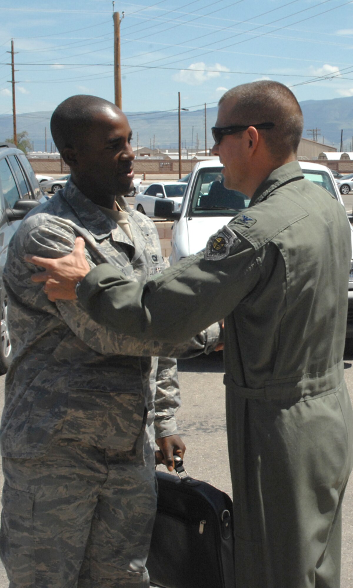 Airman 1st Class Davon Long, 49th Security Forces Squadron, is greeted by Col. Michael McGee,49th Fighter Wing vice commander, after his 179 day deployment to Kandahar, Afghanistan, at Holloman Air Force Base, N.M., Aug. 23. (U.S. Air Force photo/ Senior Airman Tiffany Trojca) 