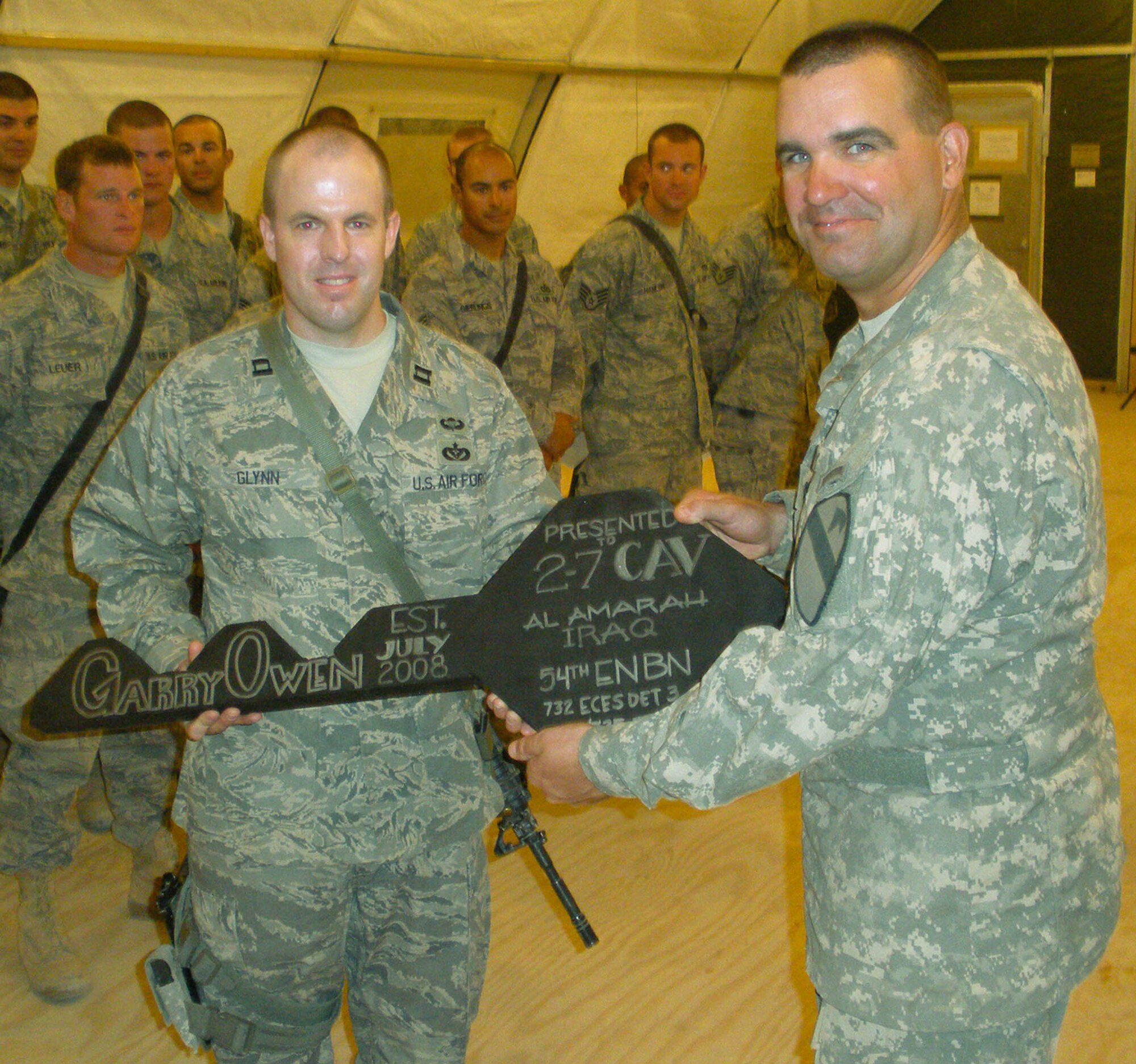 Lt. Col. Edward Bohnemann, 2nd Battalion, 7th Cavalry Regiment's commander, gives the key to the base to U.S. Air Force Capt. Glynn and the 25 Airmen of the 1st Bn., 535th Equipment Support Company,1st Bn., 535th Equipment Support Company, Aug. 8. (U.S. Army photo by 1st Lt. Dave Collins, 2nd Bn., 7th Cav. Regt., 4th BCT, 1st Cav. Div.)