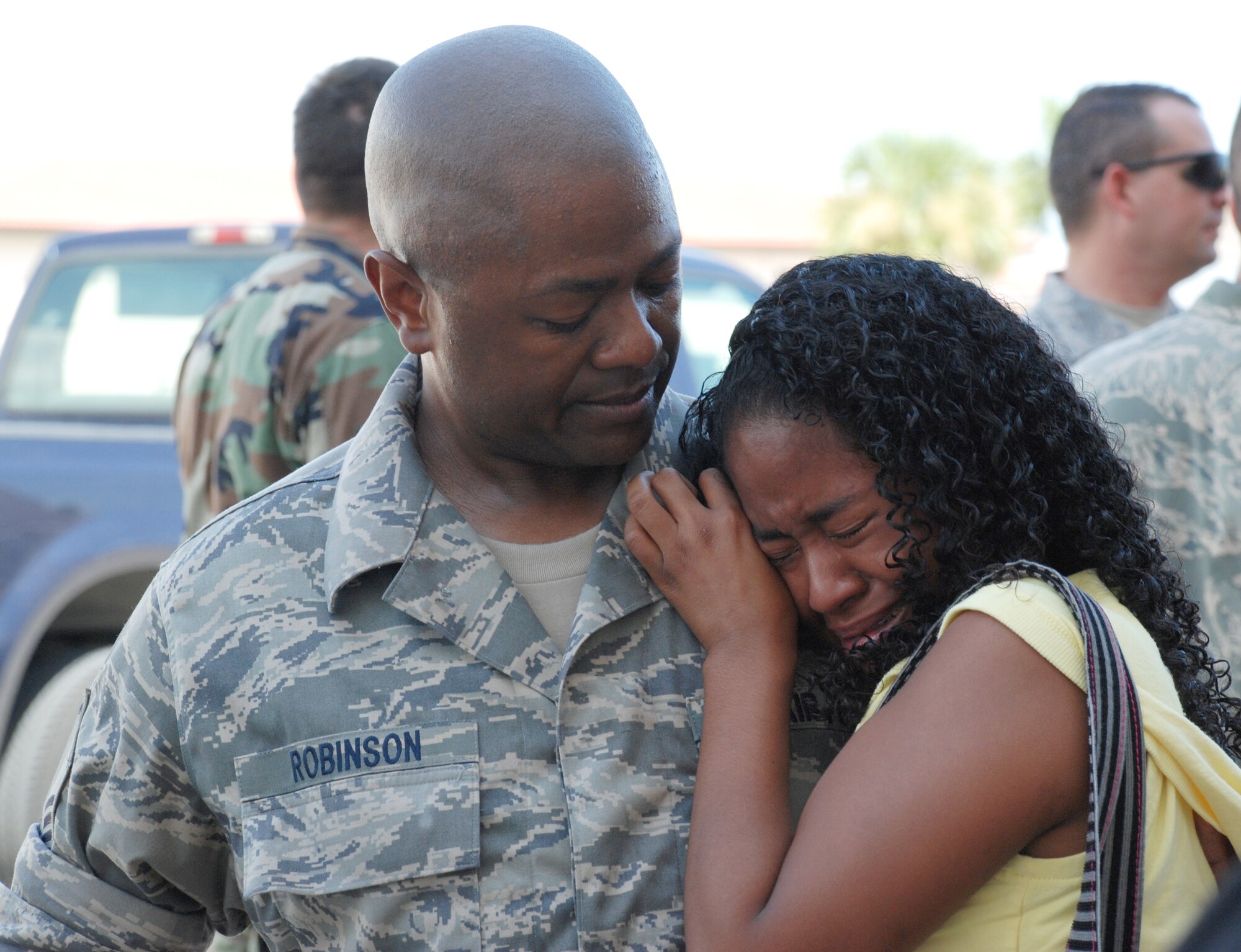 PATRICK AIR FORCE BASE, Fla. - Air Force reservist Master Sgt. Tom Robinson, 920th Rescue Wing maintenance scheduler, comforts his 19-year-old daughter Jasmine, before he heads off to Afghanistan for a seven-month deployment to support rescue services the wing will provide for personnel injured in the theater of war. (U.S. Air Force photo/Capt. Cathleen Snow)