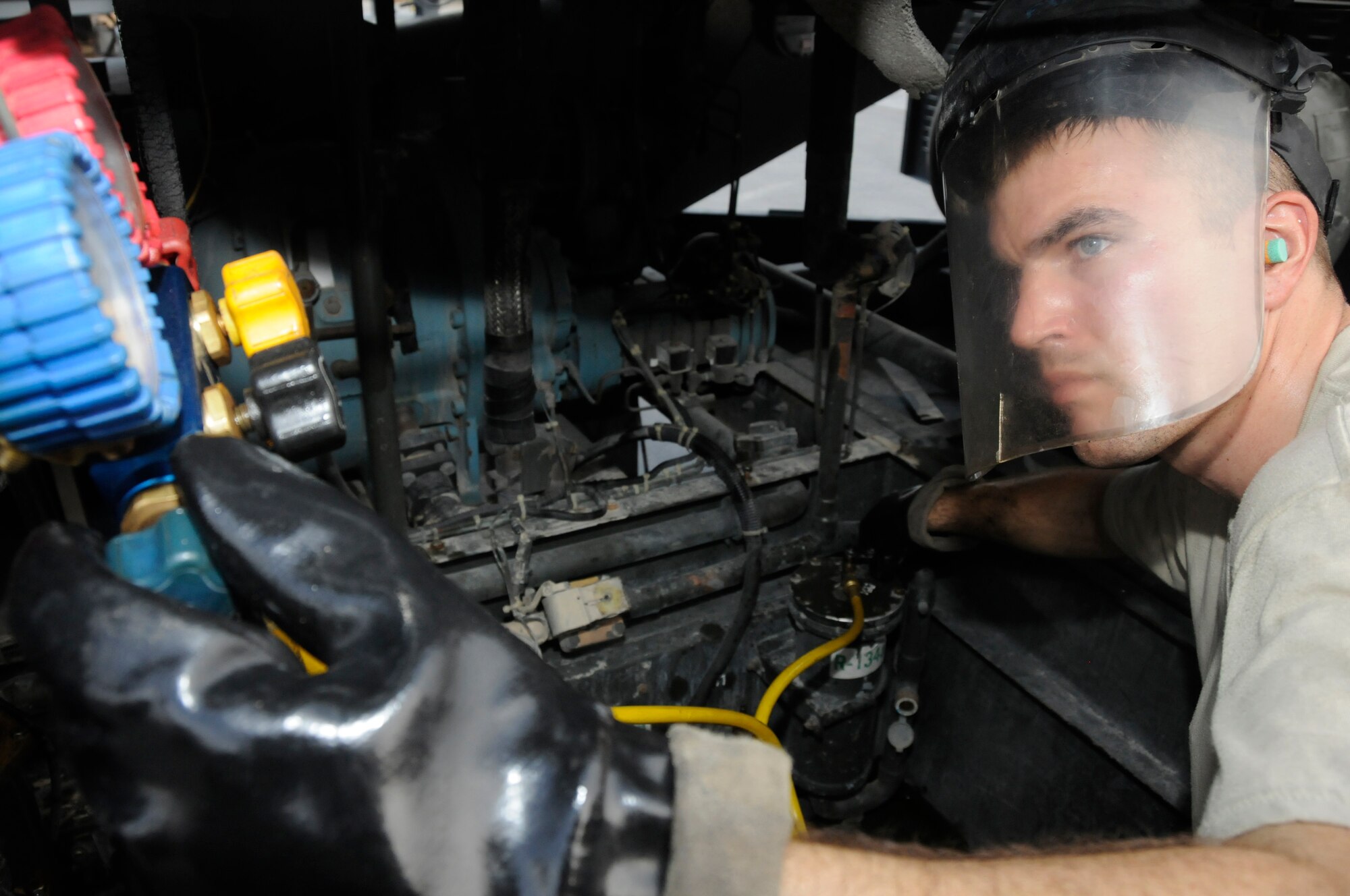 Senior Airman Shawn Scrivens, aerospace ground equipment (AGE) maintainer assigned to the 379th Expeditionary Maintenance Squadron, removes Freon from filters and angle valves Aug. 23, 2008, at an undisclosed air base in Southwest Asia. Airman Scriven is responsible for maintaining equipment required to support Air Force aircraft while on the tarmac. Airman Scriven, a native of Little Cooley, Pa., is deployed from Robins Air Force Base, Ga., in support of Operations Iraqi Freedom, Enduring Freedom and Joint Task Force-Horn of Africa. (U.S. Air Force photo by Staff Sgt. Darnell T. Cannady/Released)