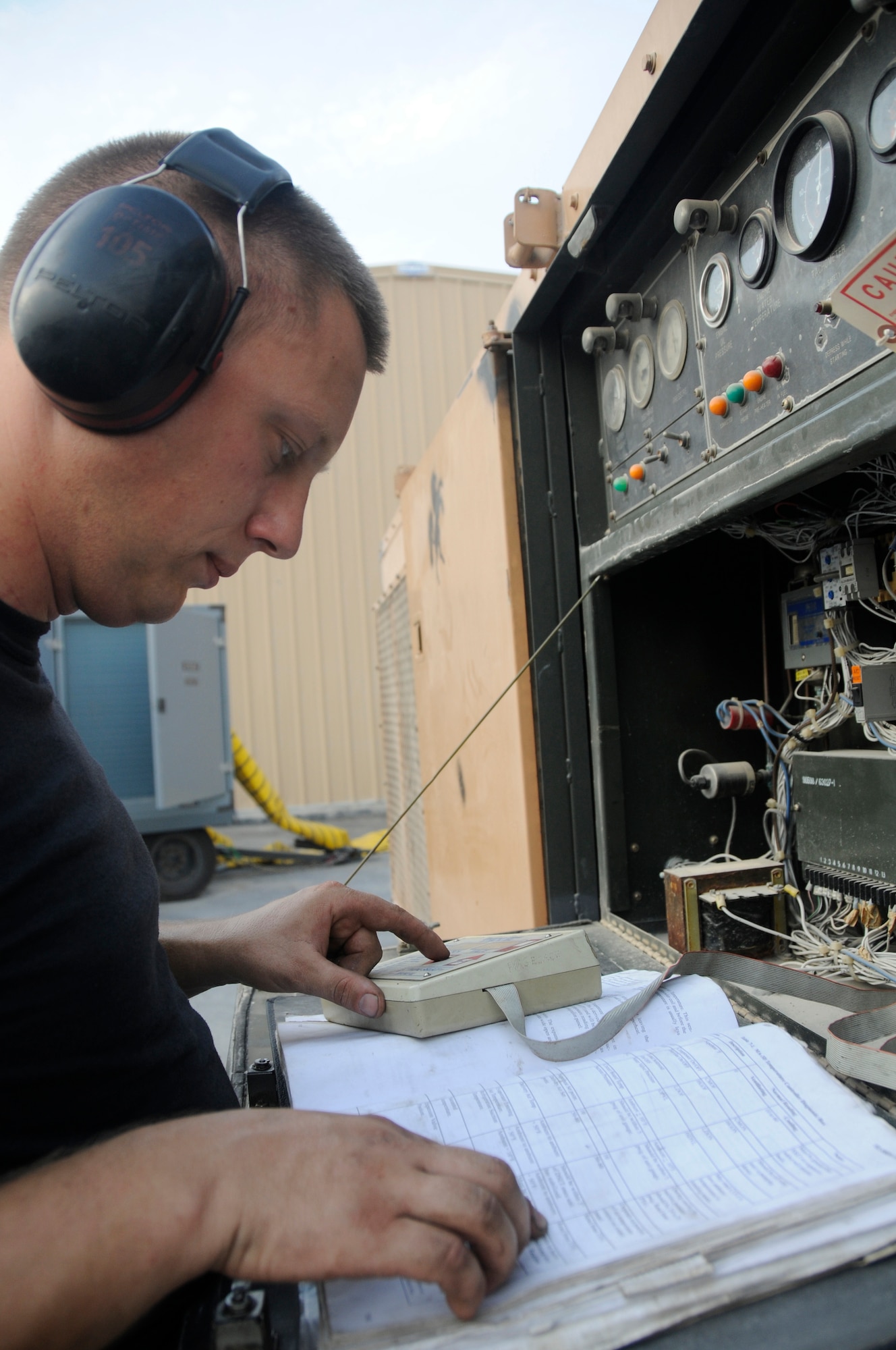 Staff Sgt. Justin Manning, aerospace ground equipment (AGE) maintainer assigned to the 379th Expeditionary Maintenance Squadron, uses a Sporlan tester and operating instructions to perform an operations check of a MA3D air conditioner Aug. 23, 2008, at an undisclosed air base in Southwest Asia. Sergeant Manning is responsible for maintaining equipment required to support Air Force aircraft while on the tarmac. Sergeant Manning, a native of New Haven, Vt., is deployed from McConnell Air Force Base, Kan., in support of Operations Iraqi Freedom, Enduring Freedom and Joint Task Force-Horn of Africa. (U.S. Air Force photo by Staff Sgt. Darnell T. Cannady/Released)