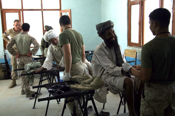 Three stretchers are used as examination tables for a Medical Capabilities (MEDCAP) health cooperative held Aug. 24 in Delaram, Afghanistan. Service members of Task Force 2d Battalion, 7th Marine Regiment, 1st Marine Division, Combined Joint Task Force Phoenix, provided medical and dental examinations for more than 180 Afghan residents. (U.S. Marine Corps photo by Cpl. Steve Cushman)