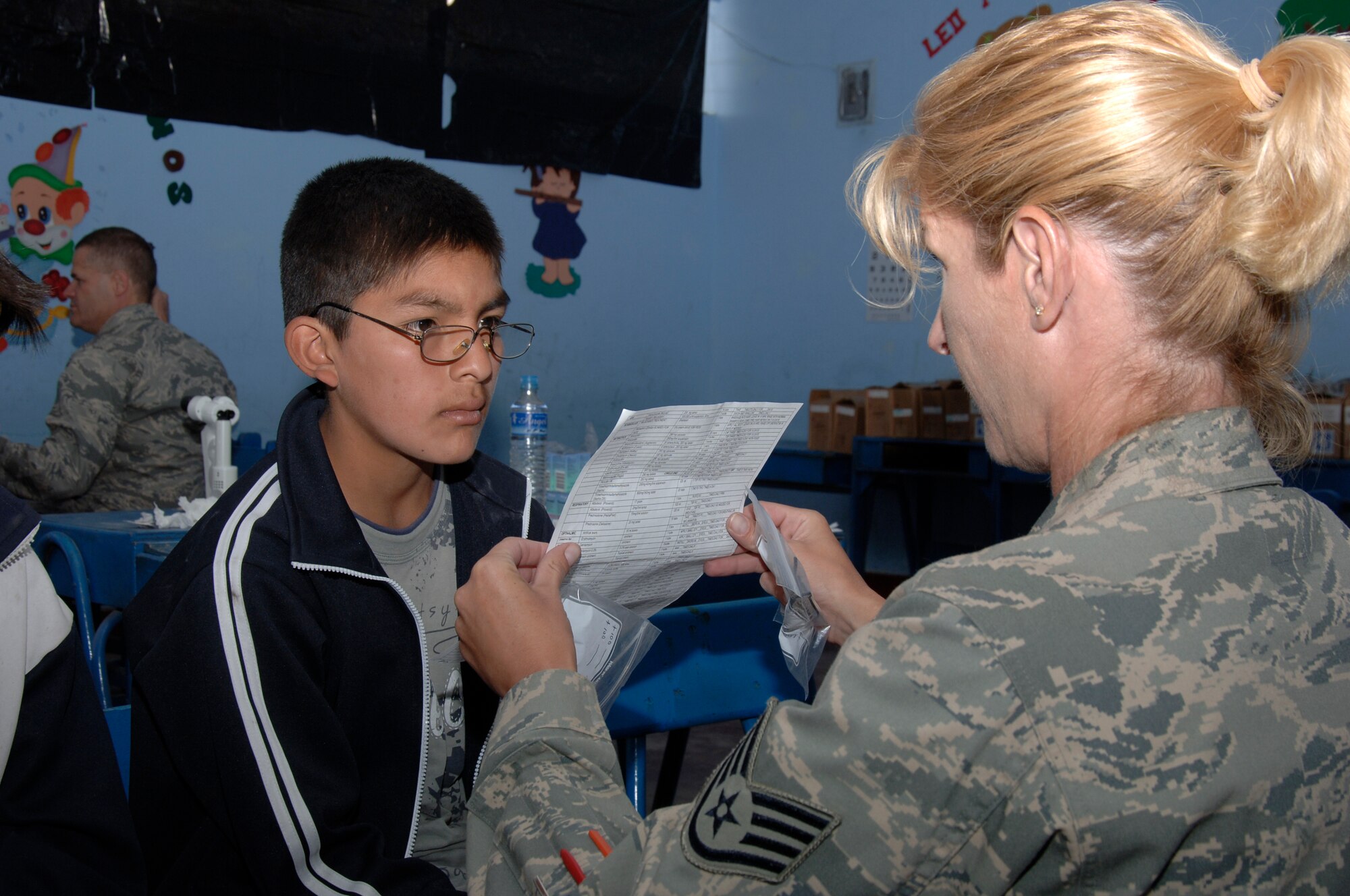 Staff Sgt. Paula Wiesmann, from the 433rd Medical Group at Lackland AFB, Texas, helps a boy test his new glasses during a medical mission in Carmen Alto, Peru, Aug. 5.  A team of 19 medical professionals deployed to Ayacucho, Peru, to support three medical exercises for New Horizons - Peru 2008, a U.S. and Peruvian humanitarian effort to bring relief to underpriviliged Peruvians. (U.S. Air Force photo/1st Lt. Mary Pekas)