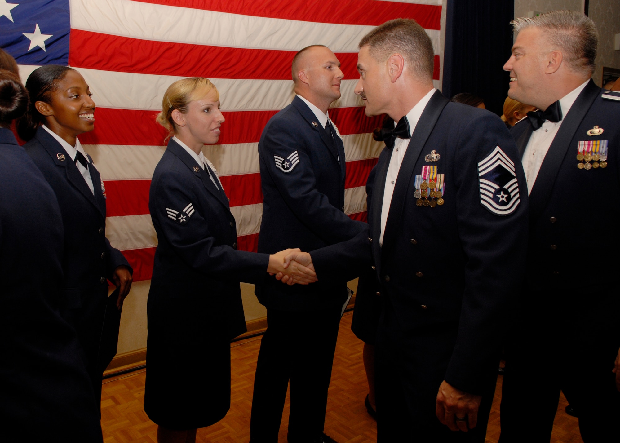 VANDENBERG AIR FORCE BASE, Calif. --  Senior Airman Jillian Voyles, with the 2nd Range Operations Squadron, shakes hands with Chief Master Sgt. Edward Smith, 30th Mission Support Group, at the Airman Leadership School graduation ceremony here Aug. 23. All 15 students with ALS Class 2008-Echo graduated after five weeks of intensive training, which prepared the Airmen for the transition to being a noncommissioned officer. (U.S. Air Force photo / Airman 1st Class Andrew Satran)
