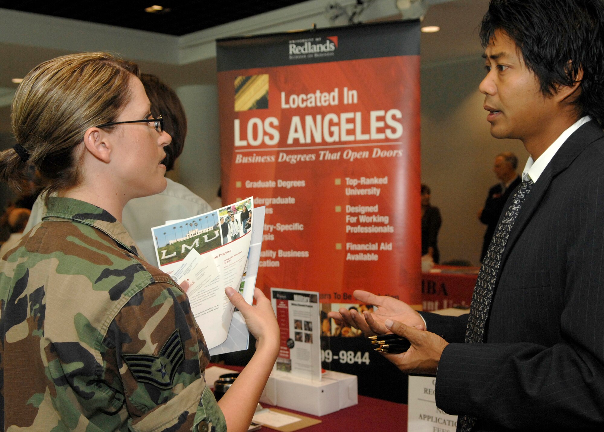 Staff Sgt. Jennifer Dodd, 61st Communications Squadron, talks to an University of Redlands representative at the annual Education Fair held at the Gordon Conference Center, Aug. 19. (Photo by Stephen Schester)