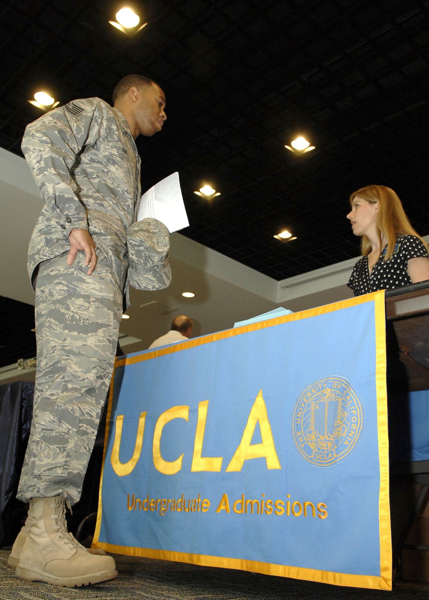 Tech. Sgt. Byron Lee, Space and Missile Systems Center Command Section, talks to a representative from University of California, Los Angeles, at the annual Education Fair held at the Gordon Conference Center, Aug. 19. (Photo by Stephen Schester)