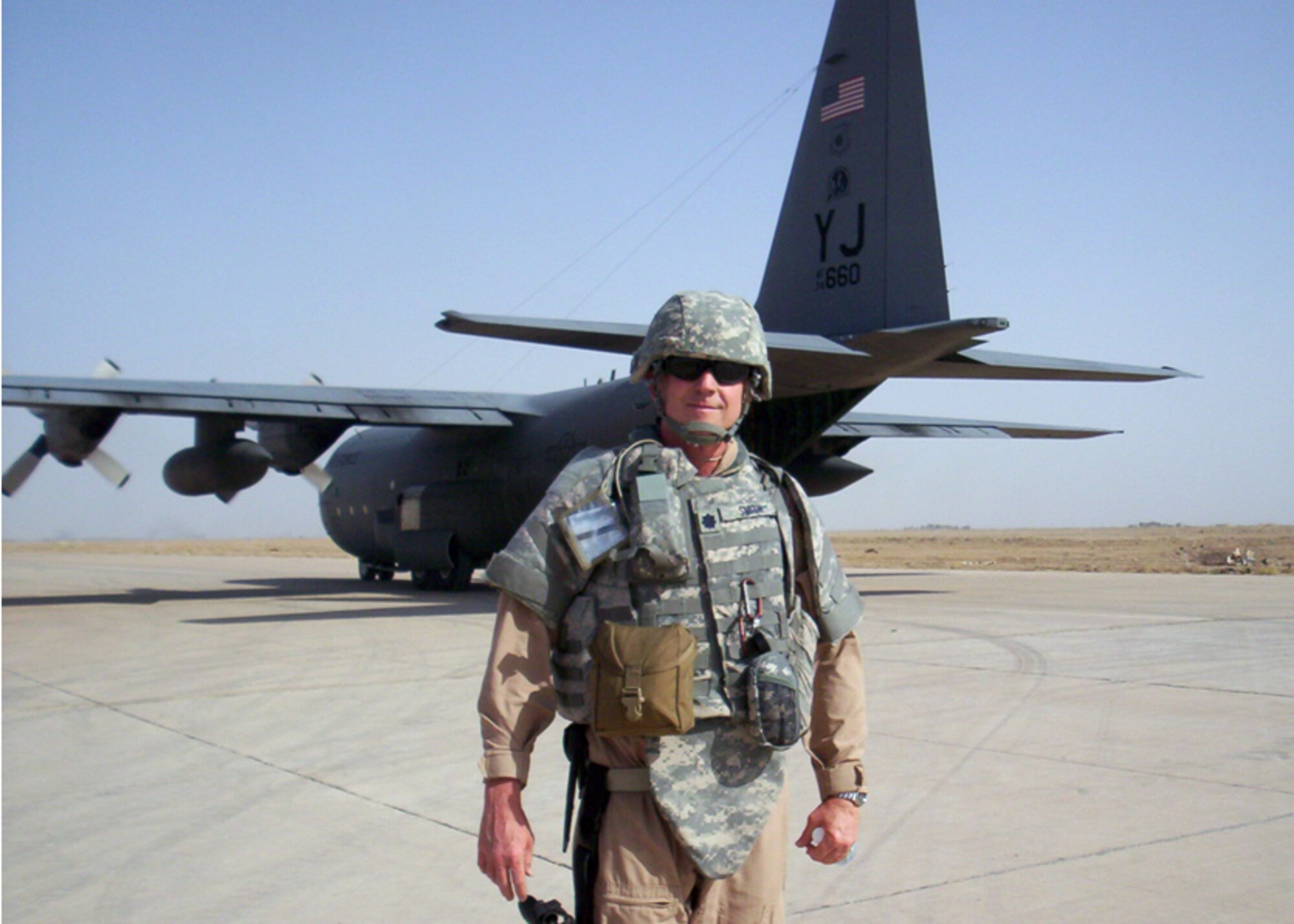 Lt. Col. Dave Smith, 412th Test Management Group deputy director, stands in front of a C-130 Hercules during his current deployment in Baghdad Iraq. (Courtesy photo)