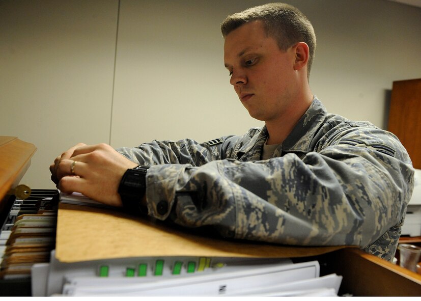 MOODY AIR FORCE BASE, Ga. -- Senior Airman Phillip Bradford, 23rd Wing military justice paralegal, checks to see if records are uniform and up-to-date here July 25. The efforts Moody Airmen put into the Unit Compliance Inspection paid off. (U.S. Air Force photo by Senior Airman Brittany Barker)