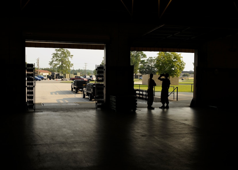 MOODY AIR FORCE BASE, Ga. -- Airmen of the 23rd Logistics Readiness Squadron pick up and delivery flight wait by the bay doors for shipments of packages to arrive here Aug. 7. After the packages come in, they will be scanned and delivered to the appropriate agency on base.  (U.S. Air Force photo by Senior Airman Brittany Barker)