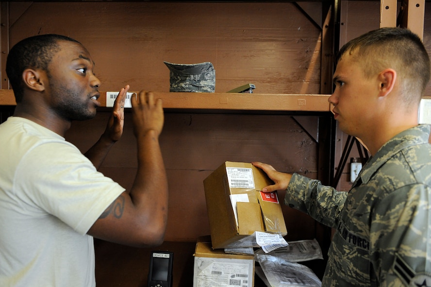 MOODY AIR FORCE BASE, Ga. -- Airman 1st Class Brian Higgs, 23rd Logistics Readiness Squadron vehicle operator, provides Airman 1st Class David Definbaugh, 23rd Logistics Readiness Squadron vehicle operator, directions to a package’s delivery location here Aug. 7. The 23rd LRS pick up and delivery flight will soon be merging with the traffic management office to create more combat capable, flexible and multi-skilled distribution Airmen. (U.S. Air Force photo by Senior Airman Brittany Barker)