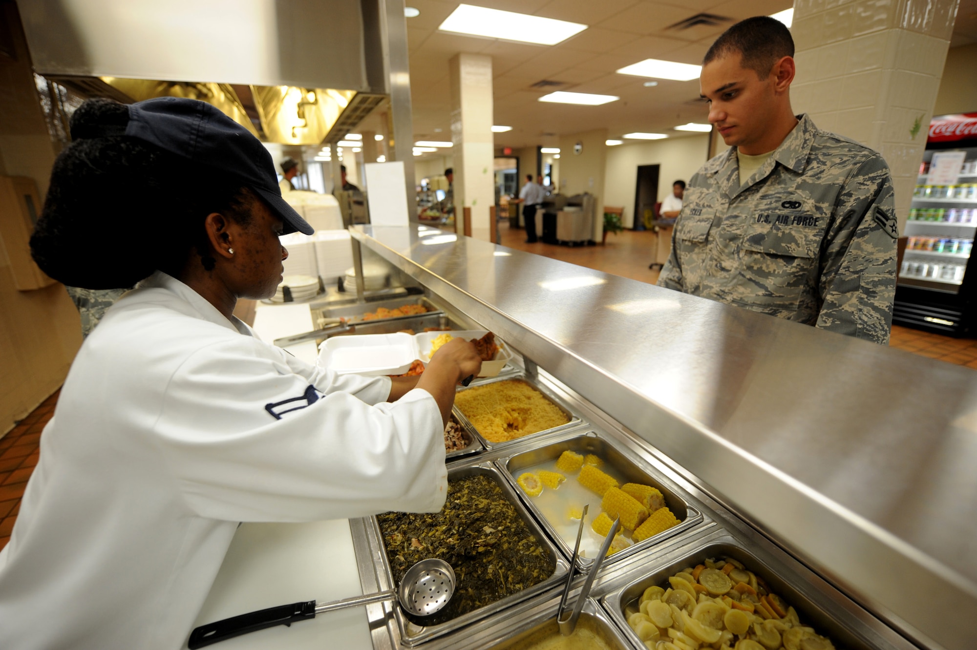MOODY AIR FORCE BASE, Ga. -- Airman 1st Class Jacquelyne Ford, 23rd Force Support Squadron food specialist, serves an airman lunch here Aug. 20. The Georgia Pines Dining Facility is open for breakfast, lunch, dinner and midnight meal. (U.S. Air Force photo by Senior Airman Gina Chiaverotti)
