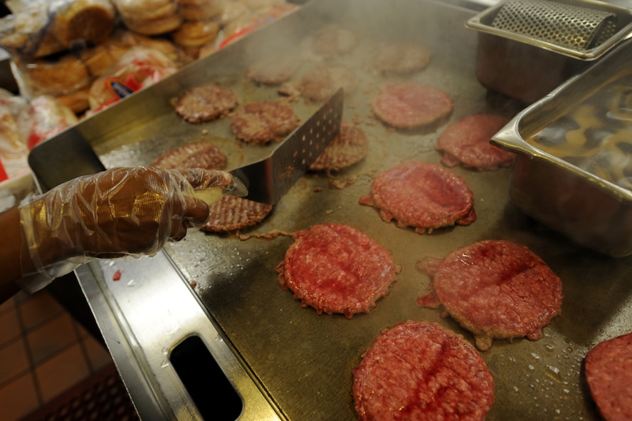 MOODY AIR FORCE BASE, Ga. -- Airman 1st Class Jacquelyne Ford, 23rd Force Support Squadron food specialist, prepares hamburgers on the grill here Aug. 20. The Georgia Pines Dining Facility provides a wide variety of food groups daily. (U.S. Air Force photo by Senior Airman Gina Chiaverotti)