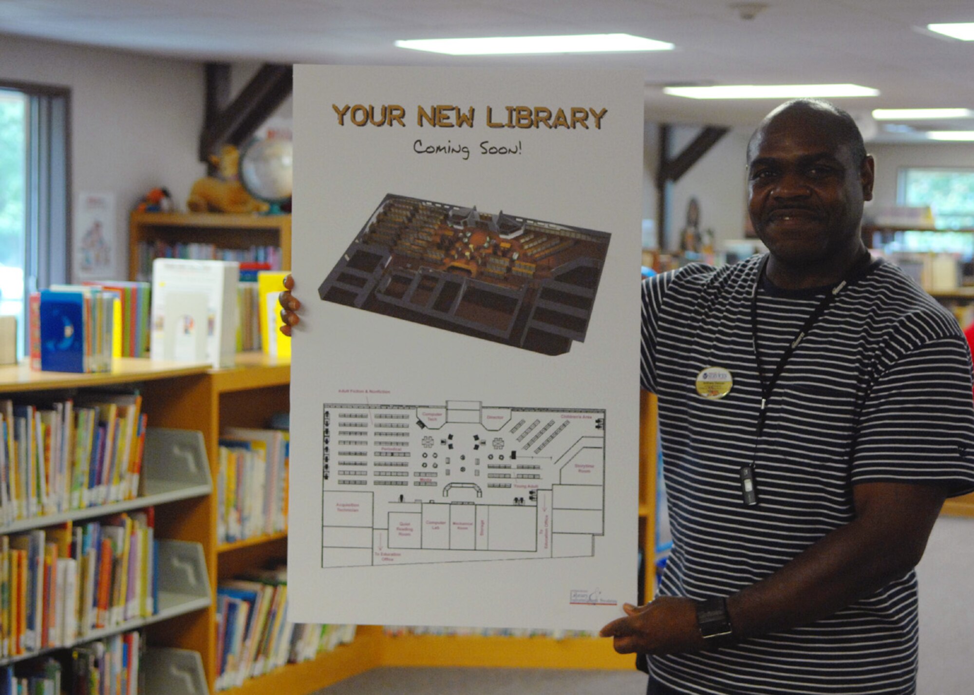MOODY AIR FORCE BASE, Ga. – Anthony Duncan, base librarian, holds the proposed plan for the new library here Aug. 20. The old Military Personnel Flight building is currently being renovated to make way for the new location of the library. (U.S. Air Force photo by Airman Joshua Green) 