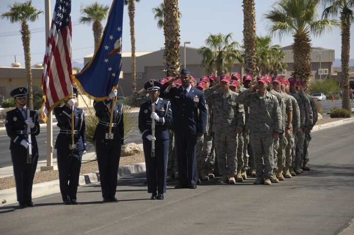 NELLIS AIR FORCE BASE, Nev. – The Nellis Honor Guard and members of the 820th RED HORSE Squadron stand in formation and salute at Staff Sgt. Cody G. Herring’s memorial service held at the Nellis Base Chapel, Aug. 20, 2008. Sergeant Herring, 820th RED HORSE Squadron special capabilities instructor, died in a motorcycle accident Aug. 16. (U.S. Air Force photo / Staff Sgt. Kenny Kennemer)