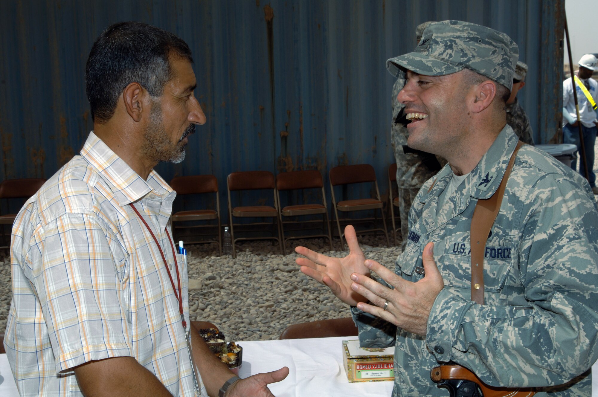 Hashim Abd Al-Amir Mahdi and Col. Sal Nodjomian converse after a ribbon-cutting ceremony to mark the signing of an Iraqi First contract in the Joint Base Balad Iraqi-based Industrial Zone here Aug. 21. The Miran Co. is establishing an I-BIZ business on base that will create approximately 70 jobs for Iraqis in six months. Colonel Nodjomian is the 332nd Expeditionary Mission Support Group commander. (U.S. Air Force photo/Tech. Sgt. Erik Gudmundson) 
