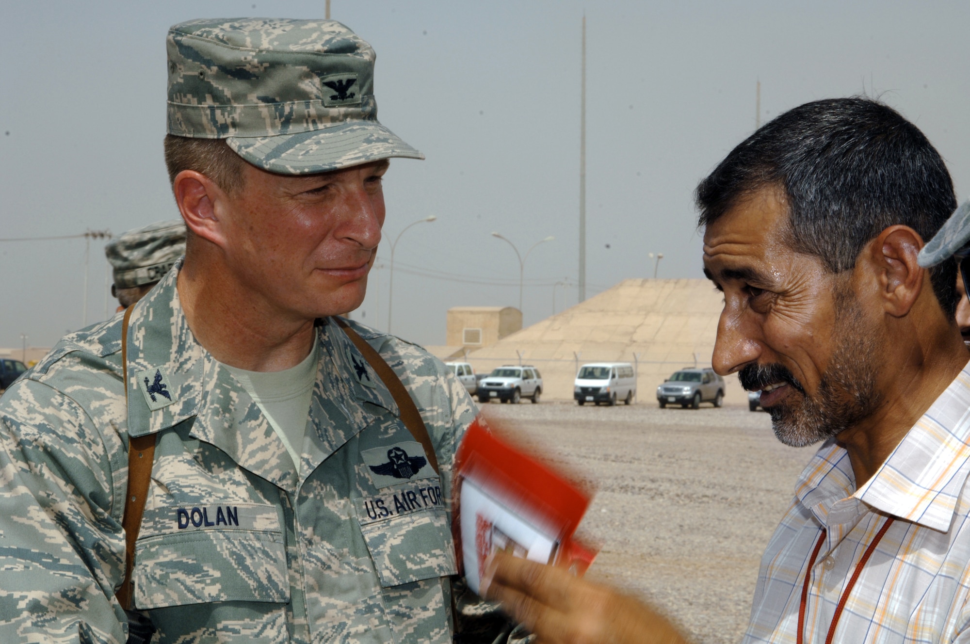 Col. John Dolan speaks with Hashim Abd Al-Amir Mahdi of the Miran Co. after a ribbon-cutting ceremony to mark the opening of an Iraqi-based Industrial Zone Aug. 21 at Joint Base Balad, Iraq. The Miran Co. is establishing an I-BIZ business on base that will create approximately 70 jobs for Iraqis within six months. Colonel Dolan is the 332nd Air Expeditionary Wing vice commander. (U.S. Air Force photo/Tech. Sgt. Erik Gudmundson) 
