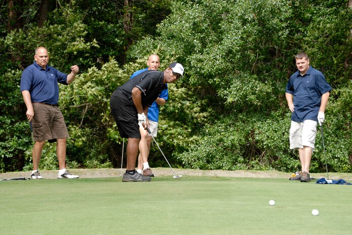 Senior Master Sergeant Clinton Harris along with his teammates watch his birdie putt on the third hole during the Air Force Ball golf tournament at Miller Golf Club in Summerville, S.C., Aug. 22. The tournament was held to raise money for the annual ball to be held Sept. 6. Tickets are still available at the 437th Airlift Wing protocol office for $35 a person. For more information call protocol at 963-8002. Sergeant Harris and his teammates are assigned to the 437th Security Forces Squadron. (U.S. Air Force photo/Master Sgt. Sean Houlihan)