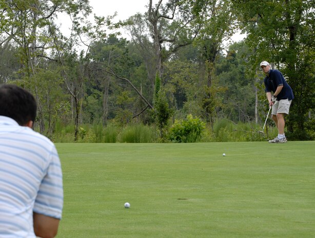 Master Sgt. Francisco Endaya watches the birdie putt of Capt. Jeff Bartlett ties on the first hole during the Air Force Ball golf tournament at Miller Golf Club in Summerville, S.C., Aug. 22. The tournament was held to raise money for the annual ball to be held Sept. 6. Tickets are still available at the 437th Airlift Wing protocol office for $35 a person. For more information call protocol at 963-8002. Sergeant Endaya and Captain Bartlett are assigned to the 437th Airlift Wing Safety Office. (U.S. Air Force photo/Master Sgt. Sean Houlihan)
