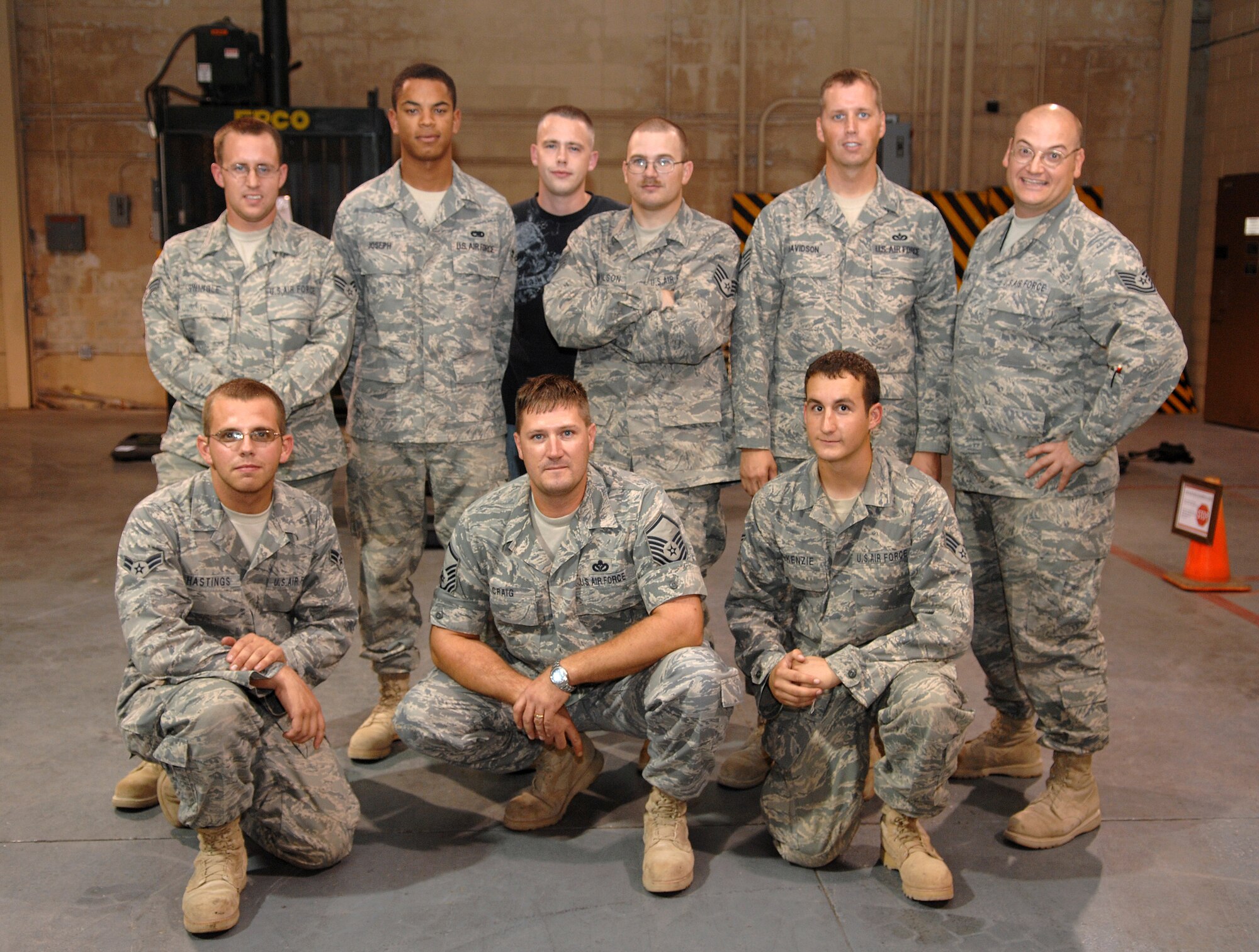 The nine-man team from the 49th Materiel Maintenace Squadron pose for a photograph at Holloman Air Force Base, N.M., August 20, upon their return from a 74-day deployment to Southwest Asia. While deployed, the team set up large structures for aircraft hangars, including one for the American Embassy in Pakistan. Top row from left to right: Senior Airman Steven Swingle, Airman 1st Class Jose Joseph, Senior Airman Thomas Carr, Staff Sgt. Ryan Wilson, Staff Sgt. William Davidson, Tech. Sgt. Shawn Odom. Bottom row from left to right: Airman 1st Class James Hastings, Master Sgt. James Craig, Senior Airman John McKenzie.(U.S. Air Force photo/Airman Sondra M. Wieseler)