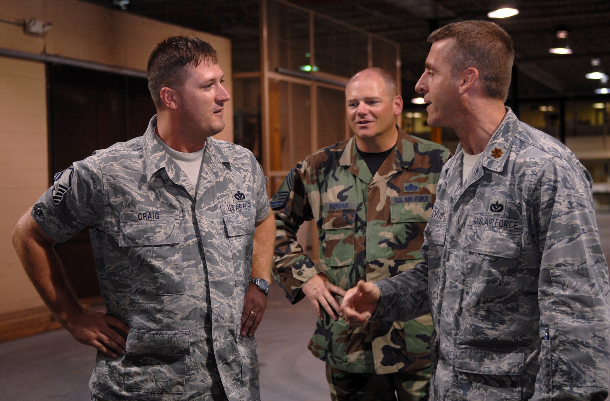 Master Sgt. James Craig, 49th Materiel Maintenance Squadron, speaks to Maj. Mark Shoviak, 49 MMS commander, and Chief Master Sgt. Richard Sheridan, 49 MMS chief, about the deployment he returned from at Holloman Air Force Base, N.M., August 20. During his deployment to Southwest Asia, his team set up large structures for aircraft hangars, including one in Pakistan for the American Embassy. (U.S. Air Force photo/Airman Sondra M. Wieseler)