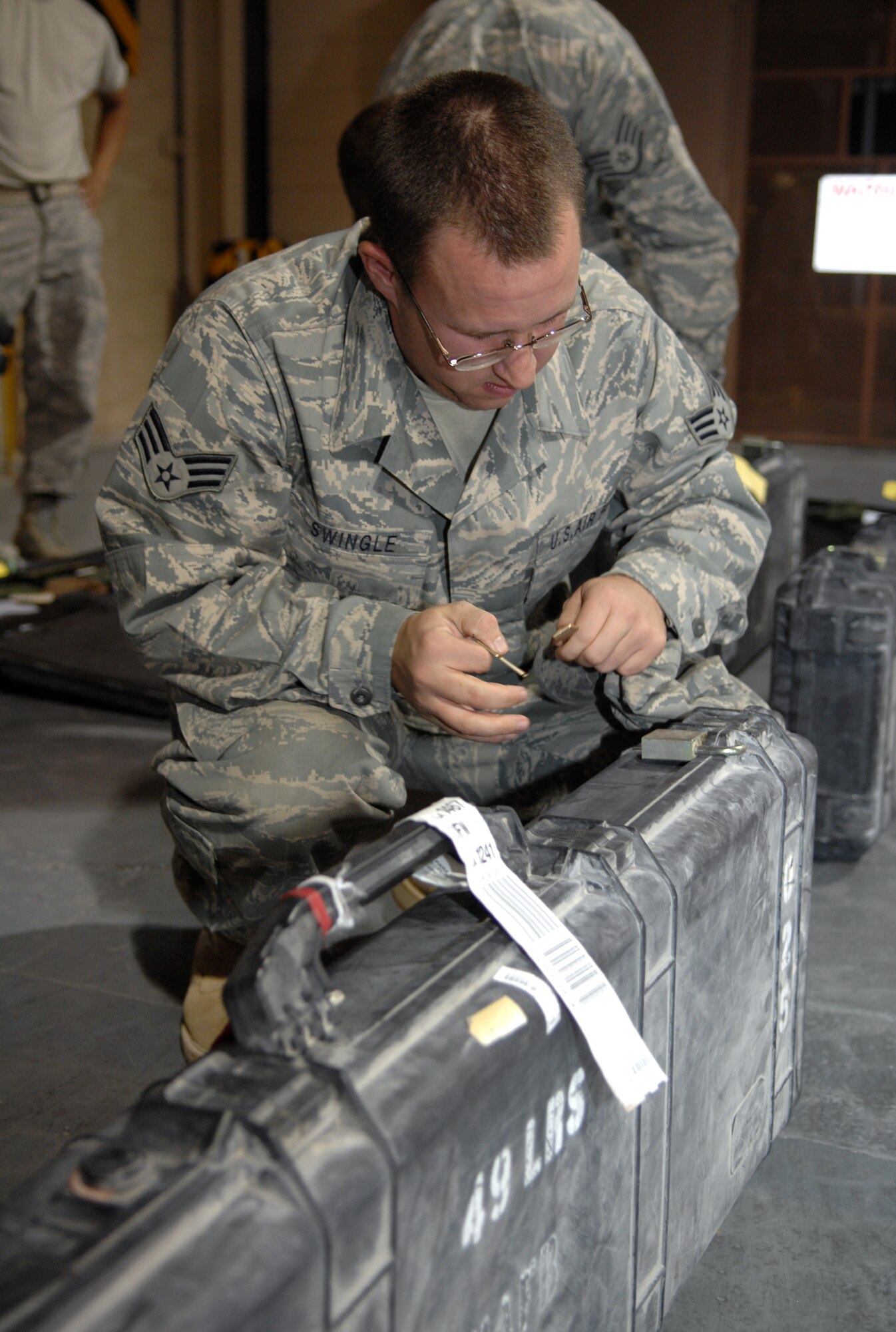 Senior Airman Steven Swingle, 49th Materiel Maintenance Squadron, opens his weapon case to return it upon returning home to Holloman Air Force Base, N.M. Airman Swingle was one of nine Airmen who returned home August 20 from a 74-day deployment where they were stationed in Southwest Asia. (U.S. Air Force photo/Airman Sondra M. Wieseler)