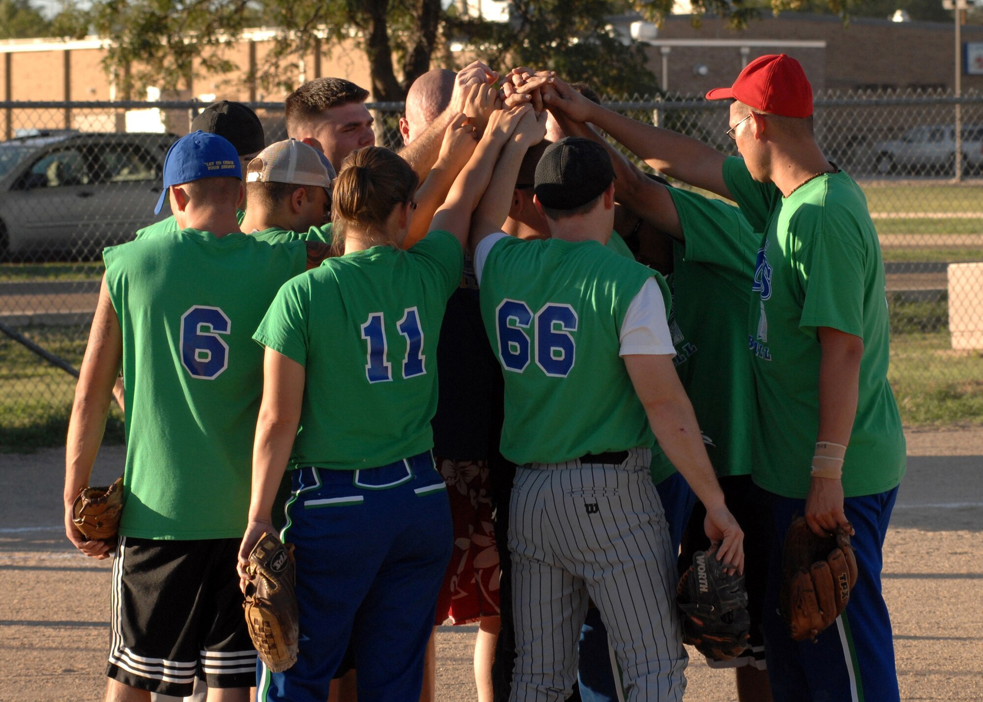 CANNON AIR FORCE BASE, N.M. - The ACES softball team (The 27th Special Operations Equipment Maintenance Squadron) congratulate each other as they celebrate their Intramural Softball Championship victory over the 27th Special Operations Logistic Readiness Squadron softball team August 21. (U.S. Air Force photo/Airman 1st Class Danielle Martin)