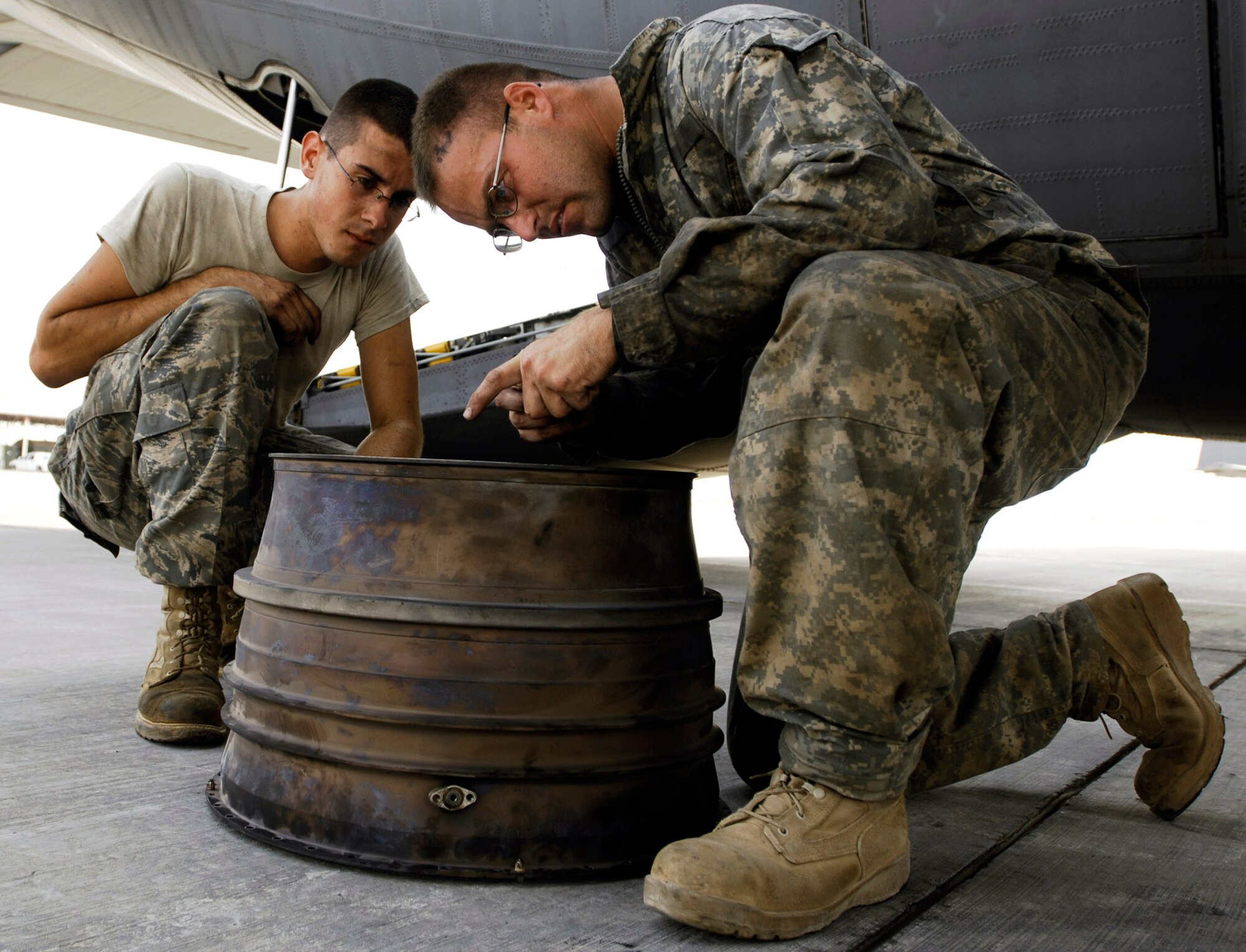 Senior Airman Sean Sweeney (left) Staff Sgt. Robert Crow and identify a crack along the rear bearing support of a C-130 Hercules engine during a post-flight inspection Aug. 22 at Joint Base Balad, Iraq. Sergeant Crow and Airman Sweeney are aerospace propulsion technicians with the 777th Expeditionary Aircraft Maintenance Squadron and are deployed from Little Rock Air Force Base, Ark. Sergeant Crow's hometown is Fort Worth, Texas. Airman Sweeney's hometown is Columbia, N.J. (U.S. Air Force photo/Airman 1st Class Jason Epley) 
