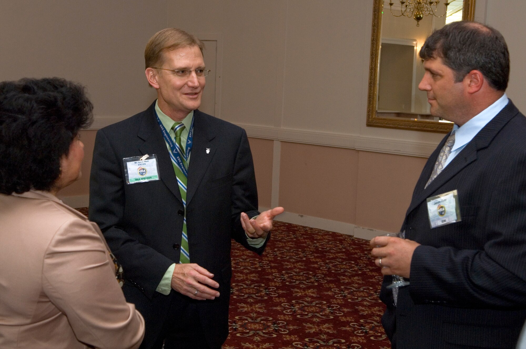 Electronic Systems Center Engineering Director Steve Wert chats with Phyllis DiTocco of the Boeing Corp. and Jason Dyer of IBM at the beginning of the Hanscom Representatives Association meeting Aug. 21.  Mr. Wert, who served as guest speaker for the meeting, said engineers need to strive for technical excellence and a complete understanding of how a system is used by operators.
