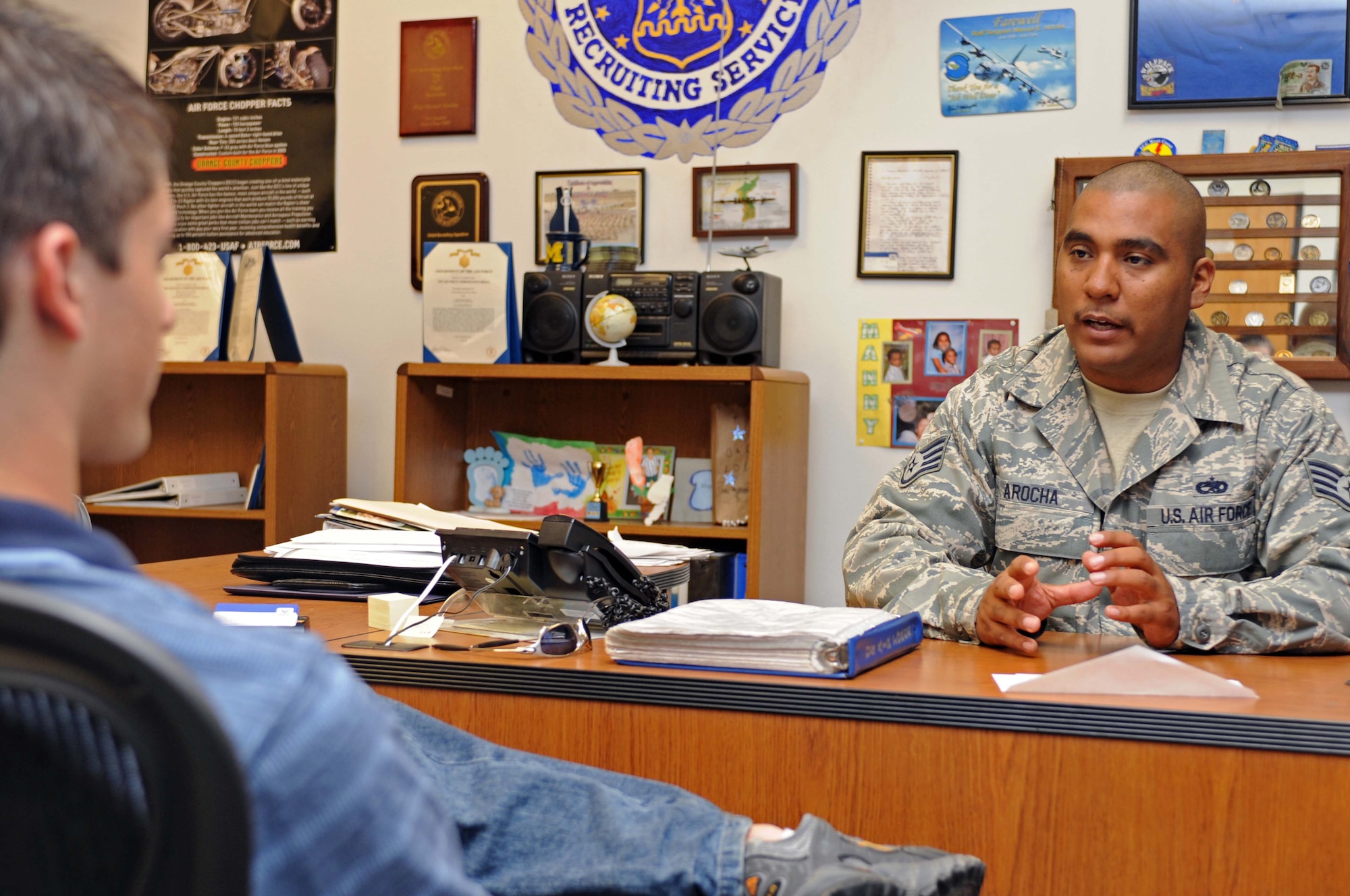 Staff Sgt. Manuel Arocha, 343th Recruiting Squadron Air Force recruiter, speaks with Jared Wiley, a Rapid City native, about joining the Air Force Aug. 20. Sergeant Arocha's recruiting office is located in the Rushmore Mall in Rapid City, S.D. (U.S. Air Force photo/Airman Corey Hook)