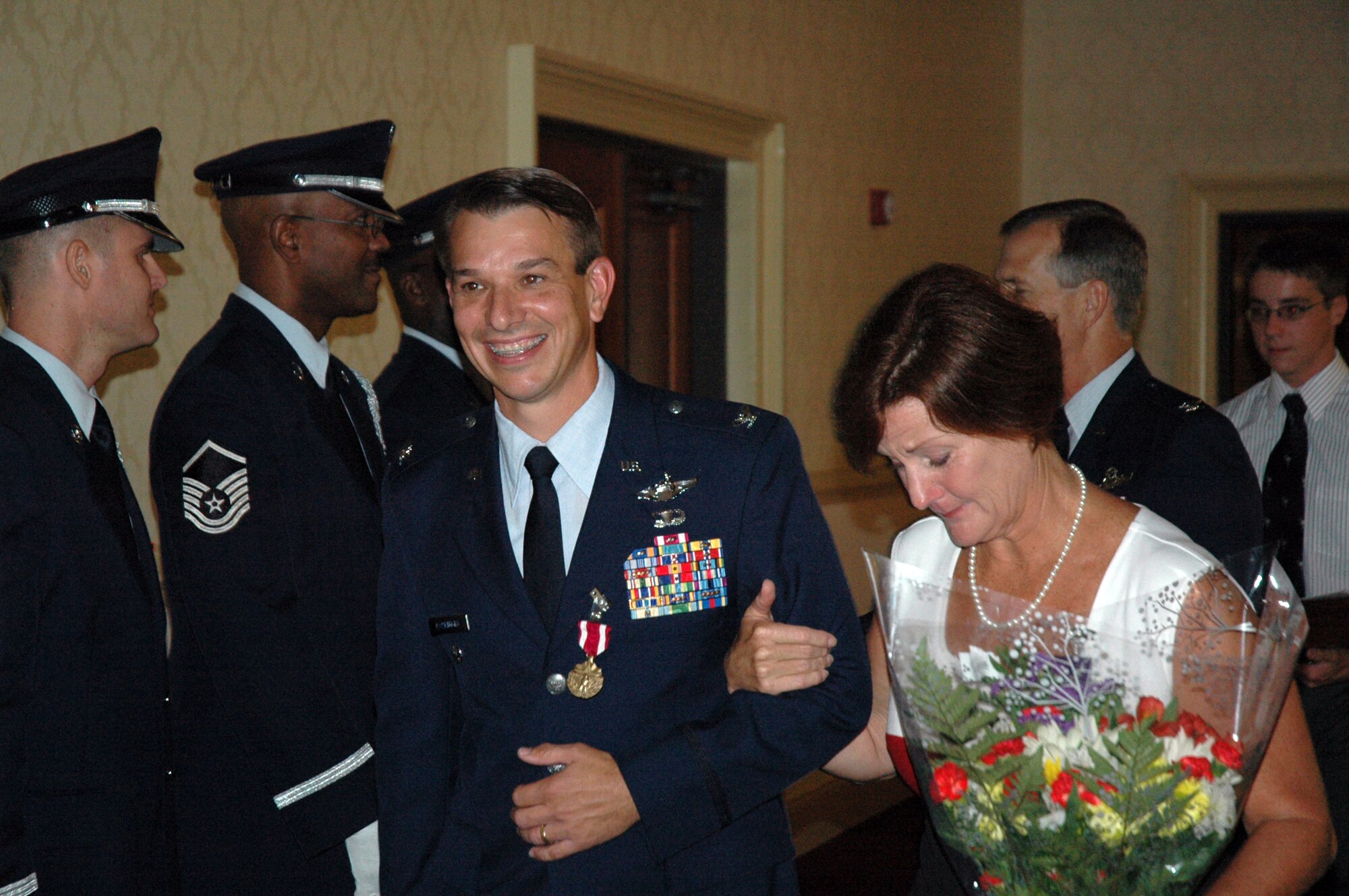 Colonel Mark Bauknight, 315th Airlift Wing Vice Commander, escorts his wife to a reception held in his honor after his official retirement ceremony was completed.  Col. Bauknight retires after 23 years of military service. (U.S. Air Force photo/Staff Sgt. Jeff Kelly)