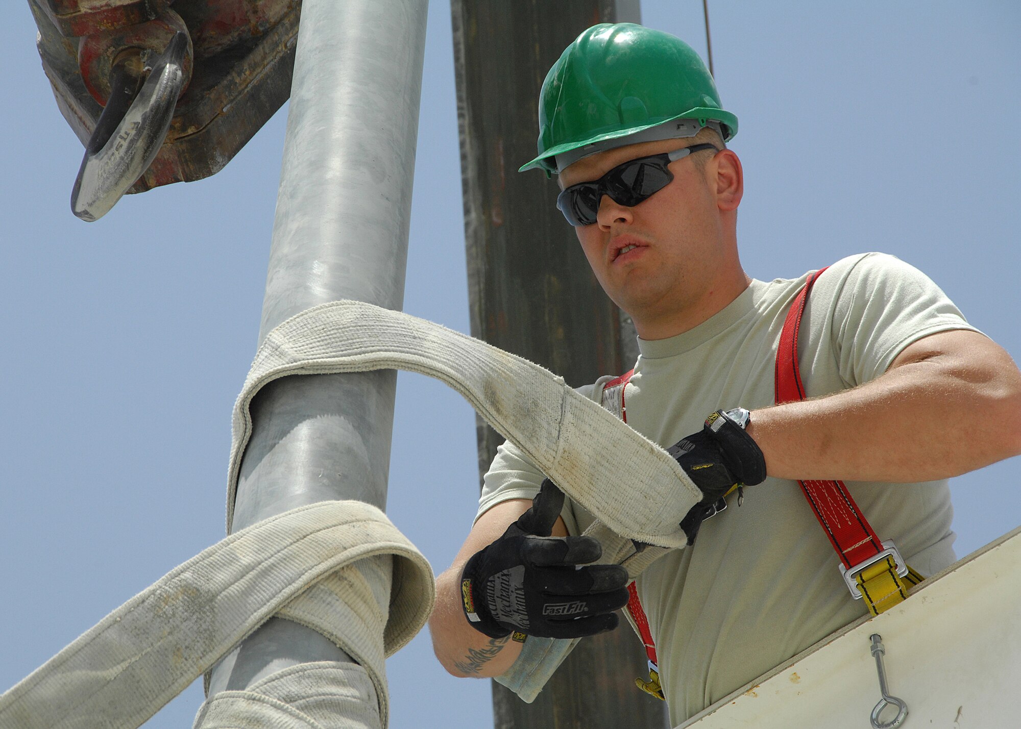 SOUTHWEST ASIA -- Senior Airman Blake Kelsey, assigned to the 386th Expeditionary Civil Engineer Squadron, removes a harness strap from a light pole on Aug. 23 at an air base in Southwest Asia. The 386th ECES installed four new light poles on the Republic of Korea Air Force compound because of previous wind damage to the poles. The installation was a joint effort between U.S. and Korean Airmen. Airman Kelsey is deployed from the Utah Air National Guard. (U.S. Air Force photo/Tech. Sgt. Raheem Moore)